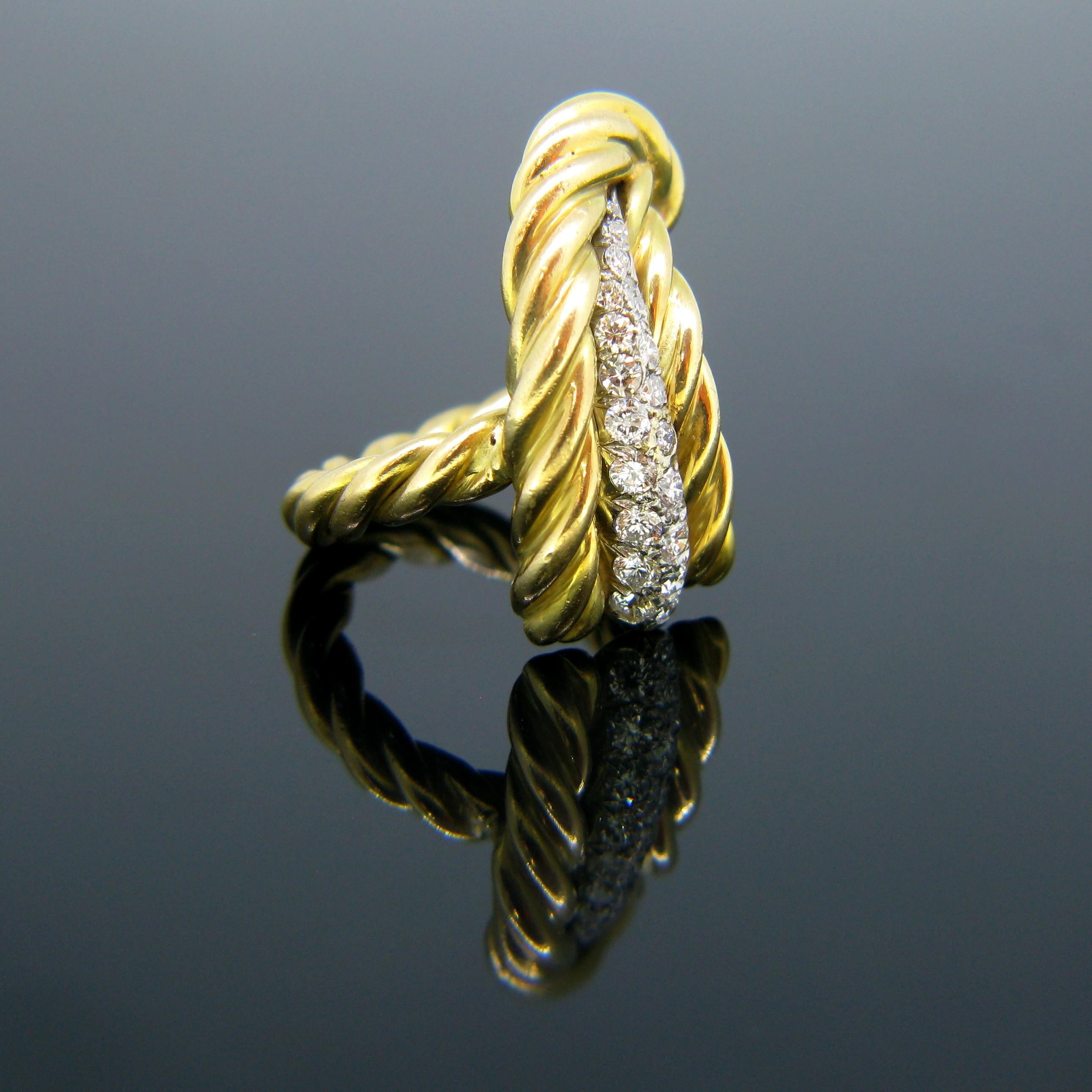 This ring comes directly from the retro era. It is made in 18kt yellow gold and the diamonds at the top are set in platinum. There are 20 round cut diamonds for a total carat weight of around 0.70ct. The ring is in the shape of a feather; the gold