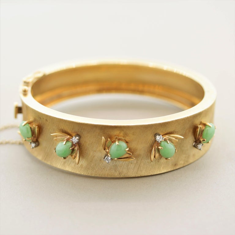 A sweet and stylish bangle bracelet, circa 1940’s. It features 5 bees with jade bodies, round brilliant-cut diamond heads, and gold wings! They are set on the front half of the bangle giving you 5 companions wherever you go! Made in 14k yellow gold