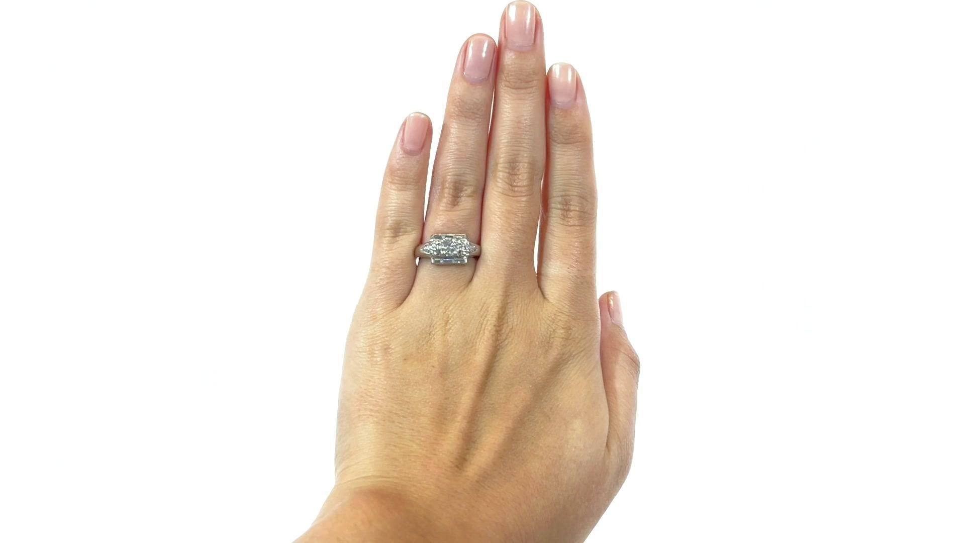 Retro Diamond Platinum Engagement Ring. Featuring a transitional cut diamond approximately 0.55 carat, F-G color, VS clarity. Accented by 12 Round Brilliant Cuts, approximately 0.12 carat, and 6 baguettes approximately 0.32 carat, G-H color, VS.