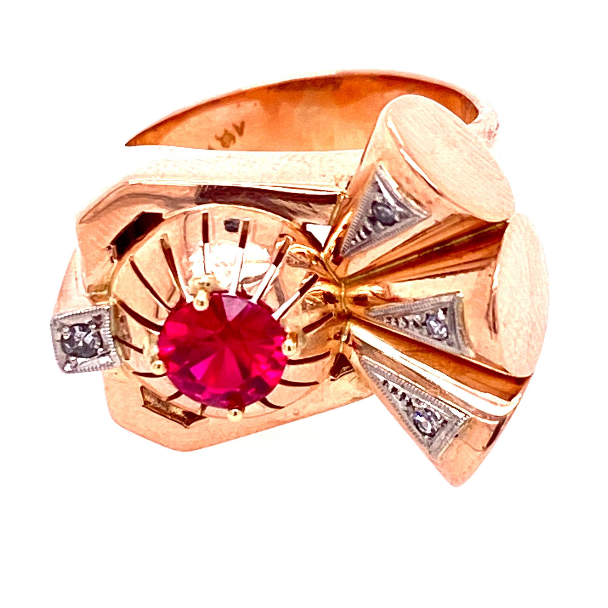 Retro cocktail ring fashioned in rose gold and white gold. The 1940's ring features an approximately .65 carat genuine red ruby and diamond accents. Currently the ring is size 5.75 (can be sized), and measures 20mm in width. 