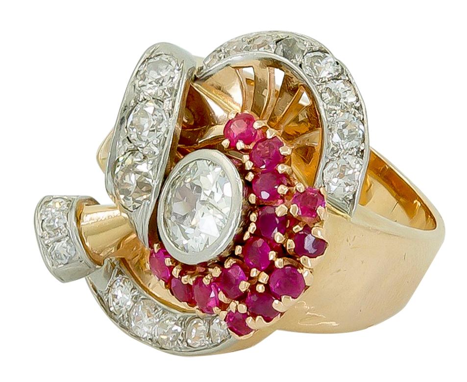 Retro Diamond Ruby Cocktail Ring 14k Rose Gold and White Gold.
A unique design dating from the 1940s, with a center Old European-cut diamond surrounded by a cornucopia of gems. The non-traditional configuration is progressive for the time, with an