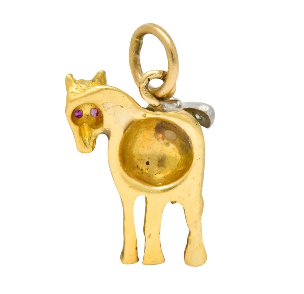 Designed as a donkey with it’s head turned back

Featuring applied platinum bow with two single cut diamonds, weighing approximately 0.03 carat total, eye-clean and white

With two tiny round cut ruby eyes

Sweet textured gold detailed body

Tested