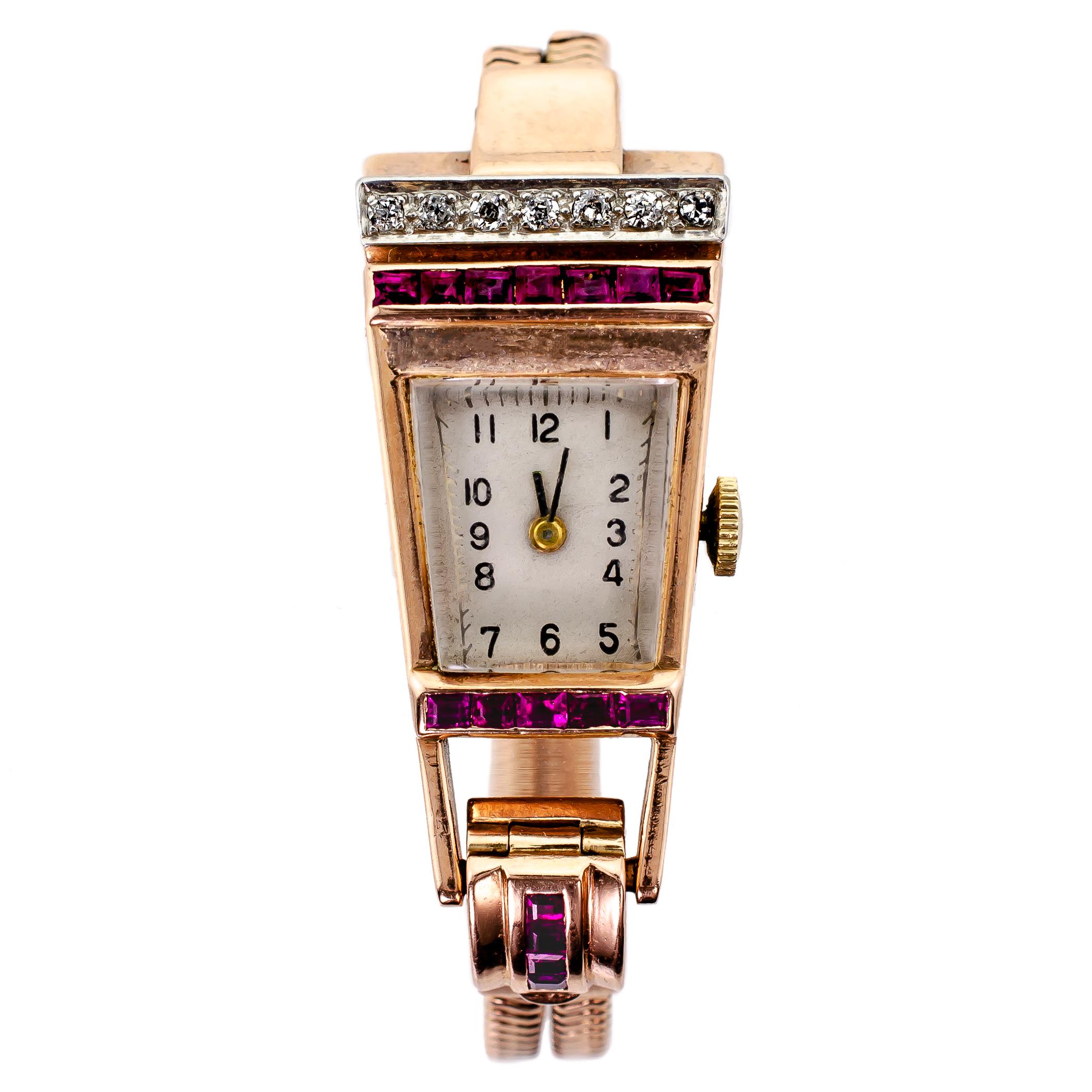 Wonderful Retro Circa 1940 diamond ruby rose gold and platinum geometric style lady's wristwatch set with seven (7) round diamonds total weight approx .56 cts. full cut and 12 caliber cut rubies deep in color with 14 karat double snake chain and 14k