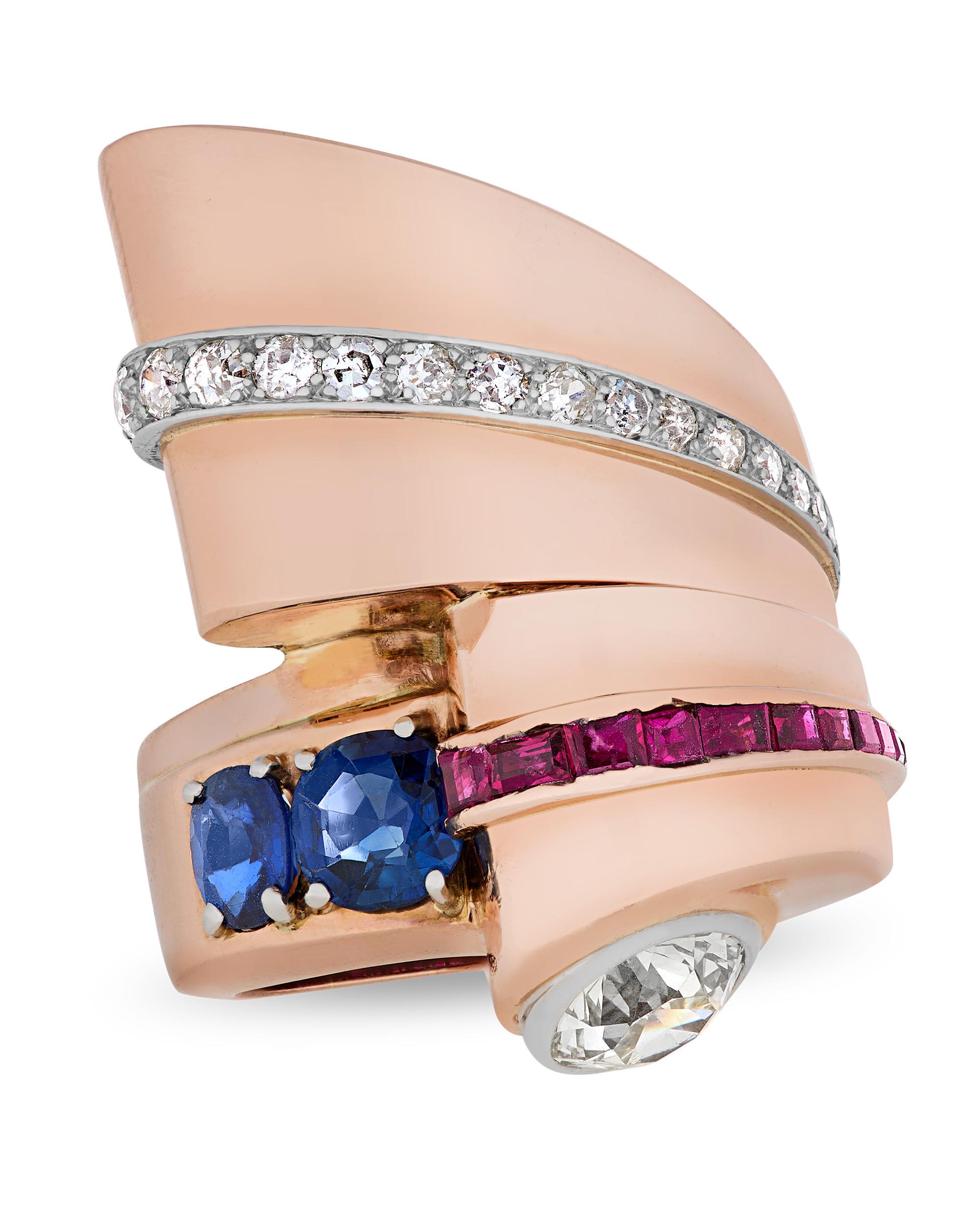 Bold geometry and vibrant color define this sculptural Retro ring from the 1940s. Set within the composition is a 2.00-carat Old European cut diamond, complemented by rich blue sapphires totaling 1.75 carats and stunning rubies totaling 0.90 carat.