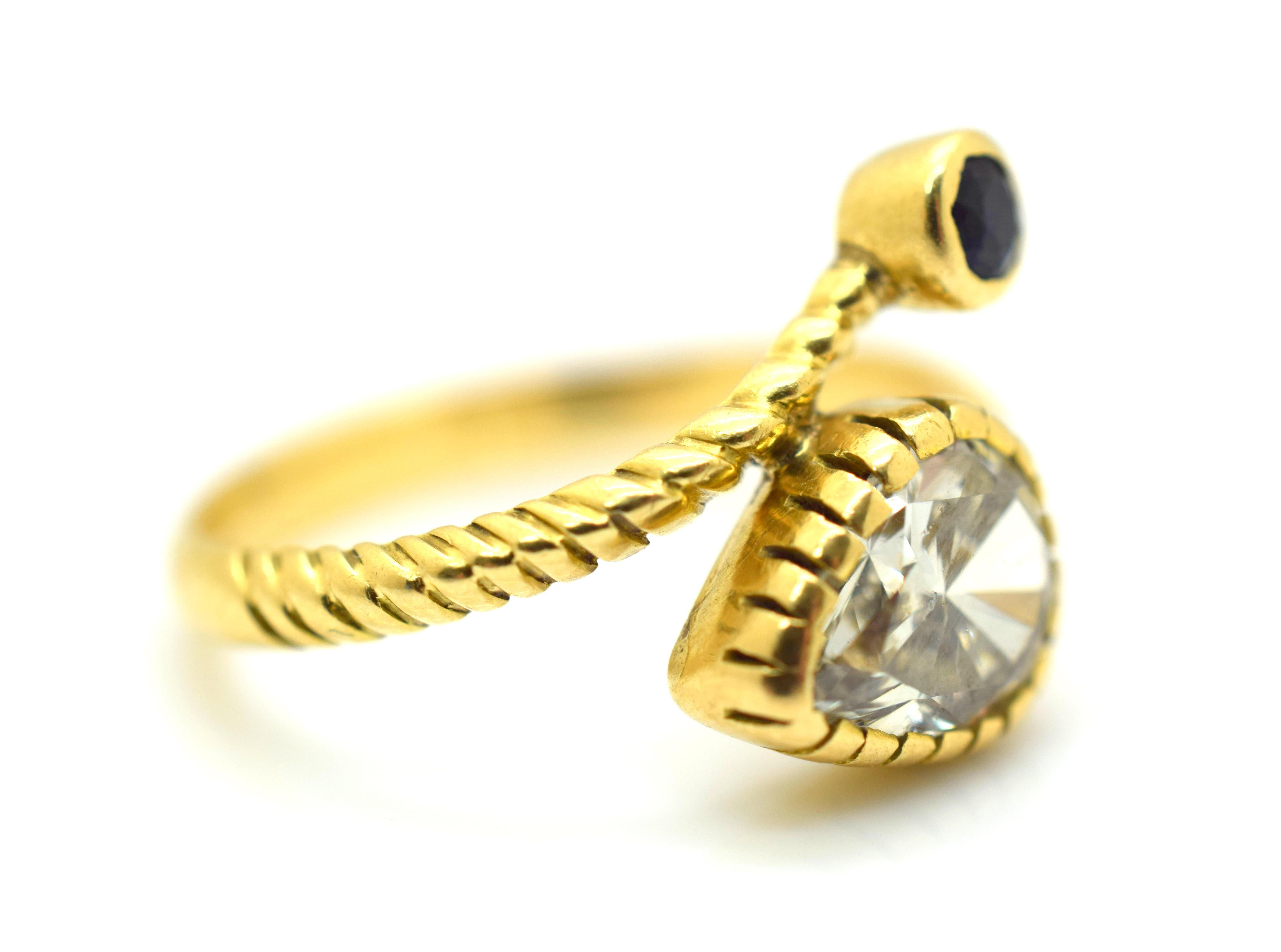 Amazing Diamond Snake Ring set in 18k Yellow Gold. This retro ring is highlighted with one bezel set natural Pear Shape Diamond. The Diamond shows K-L color and Vs clarity. Diamond is approximately 1.40 ct. Shadows in pictures and bezel setting make