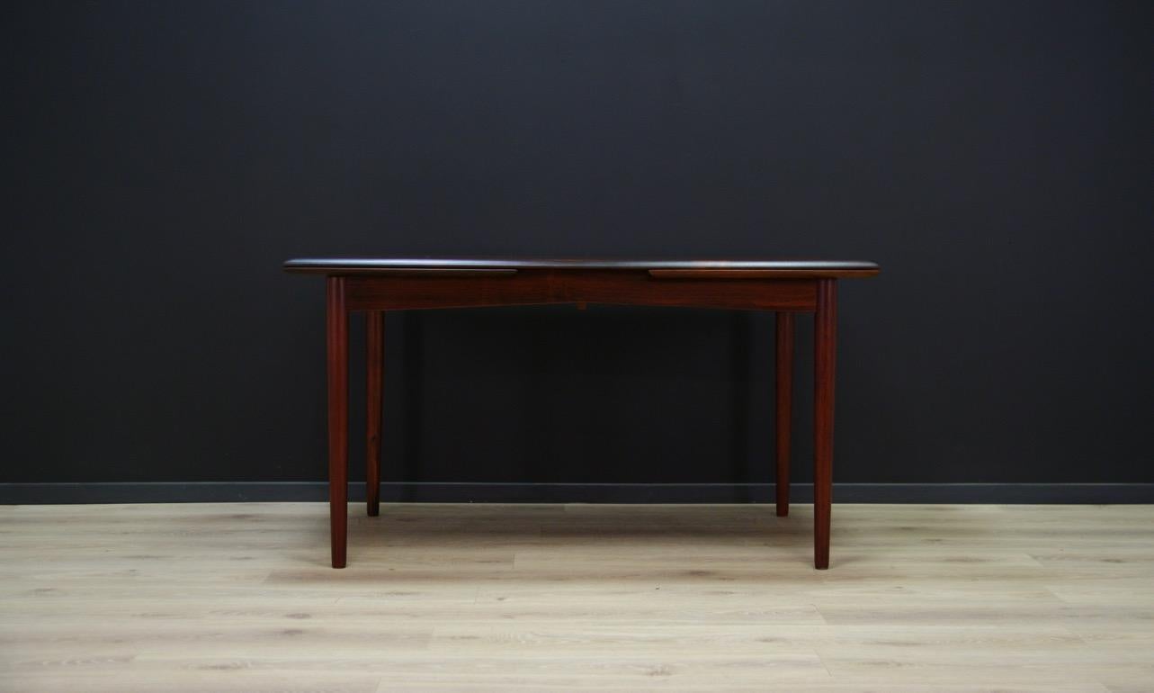 Fantastic table from the 1960s-1970s, Scandinavian design, minimalist form finished with rosewood veneer, legs made of solid rosewood. In addition, the table has two pull-out inserts. Preserved in good condition (small bruises and scratches) -