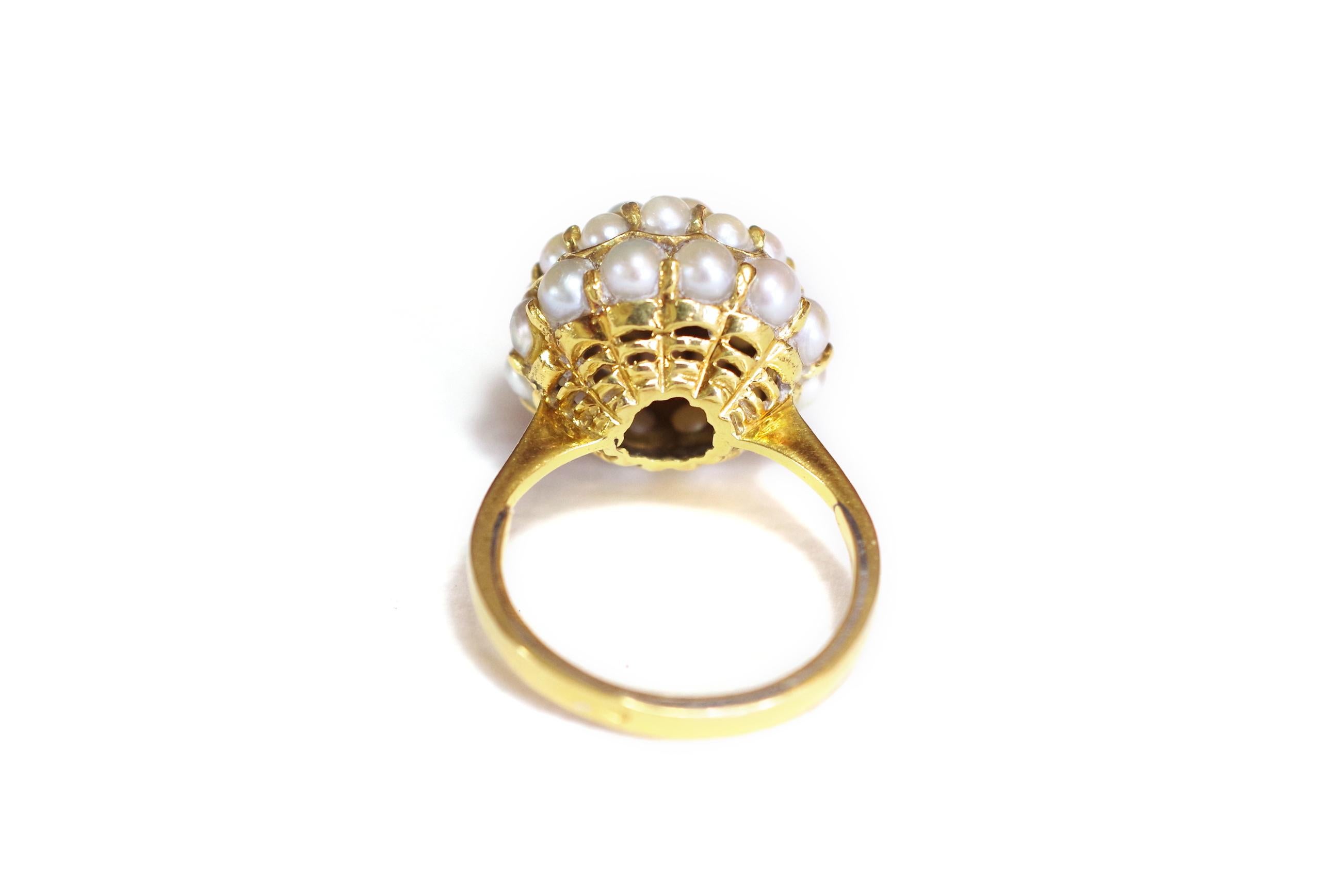 Retro dome pearl ring made of 18 karat yellow gold with Midnight Blue enamel accents. The dome is set with 30 small seed pearls. Pearl size ranges from 2.5 to 3 mm in diameter. Italian work, Retro period, end of the 1950s.

Owl hallmark.

Retro