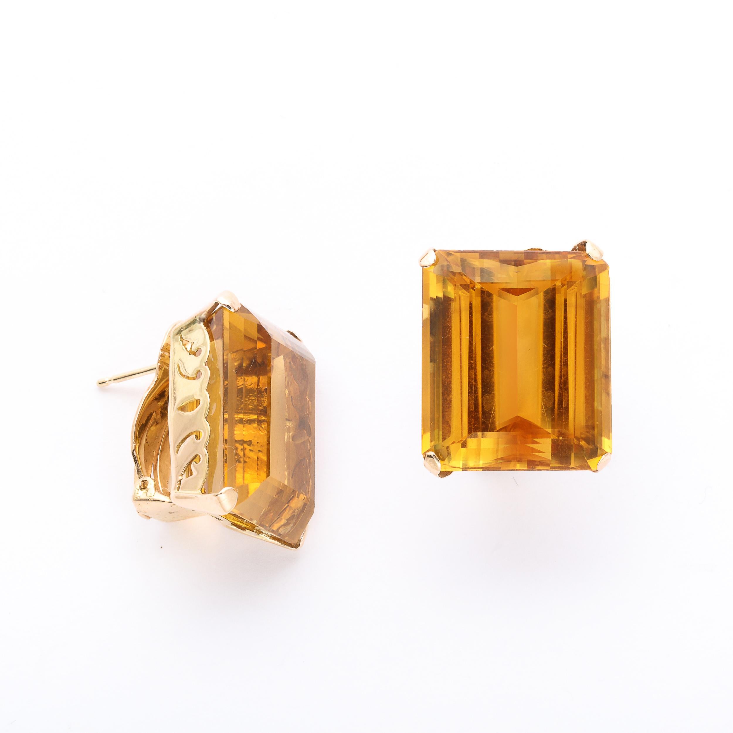 These Bold and glamorous earrings are set in 18k Rose gold  with 20 carats each of emerald cut citrines in a scrolling mount. They are fitted for pierced ears but can easily be converted back to just clip on. These earrings are very 1940s Hollywood