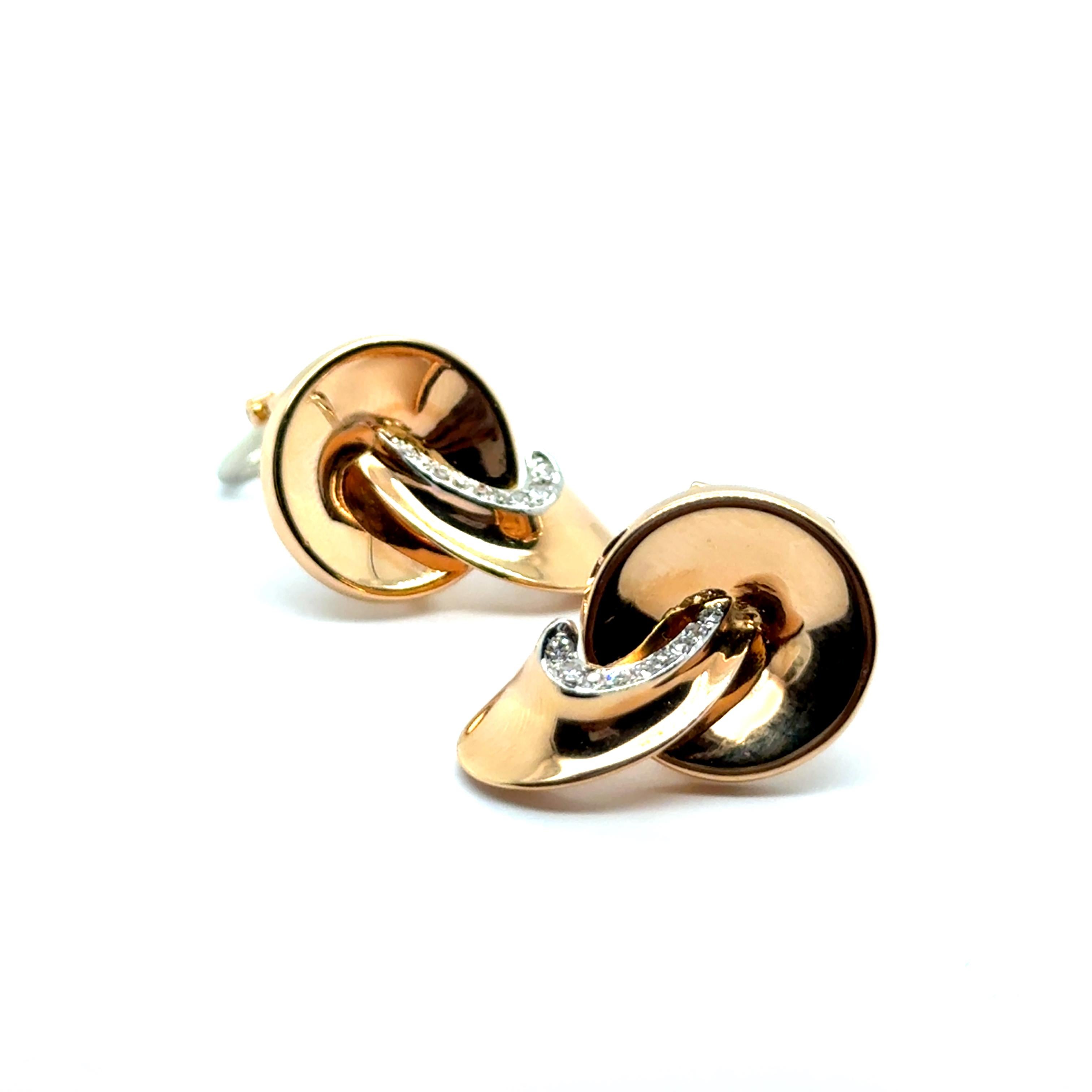 These elegant Gübelin earrings showcase a sculptural design in 18 karat red and white gold, accented by graceful curves and delicate diamond embellishments. 

Eighteen 8/8 cut diamonds G-H colour and vs clarity totaling 0.10 ct. add a subtle yet