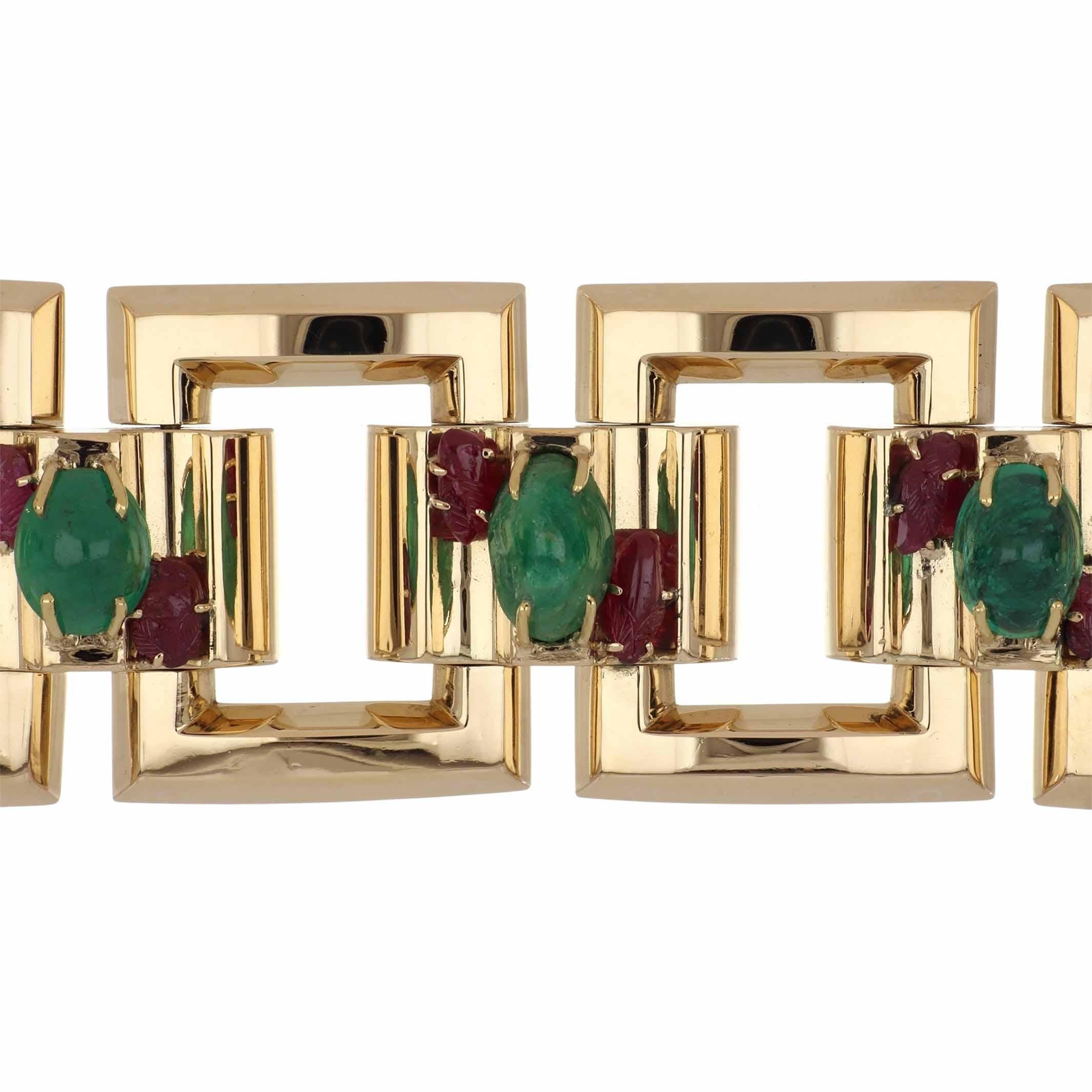 An estate Retro wide square link bracelet featuring cabochon emerald center sections flanked by free-form carved rubies, set in 14k yellow gold. The bracelet contains 5 oval cabochon emeralds and 10 free form carved rubies. The bracelet is 8 inches