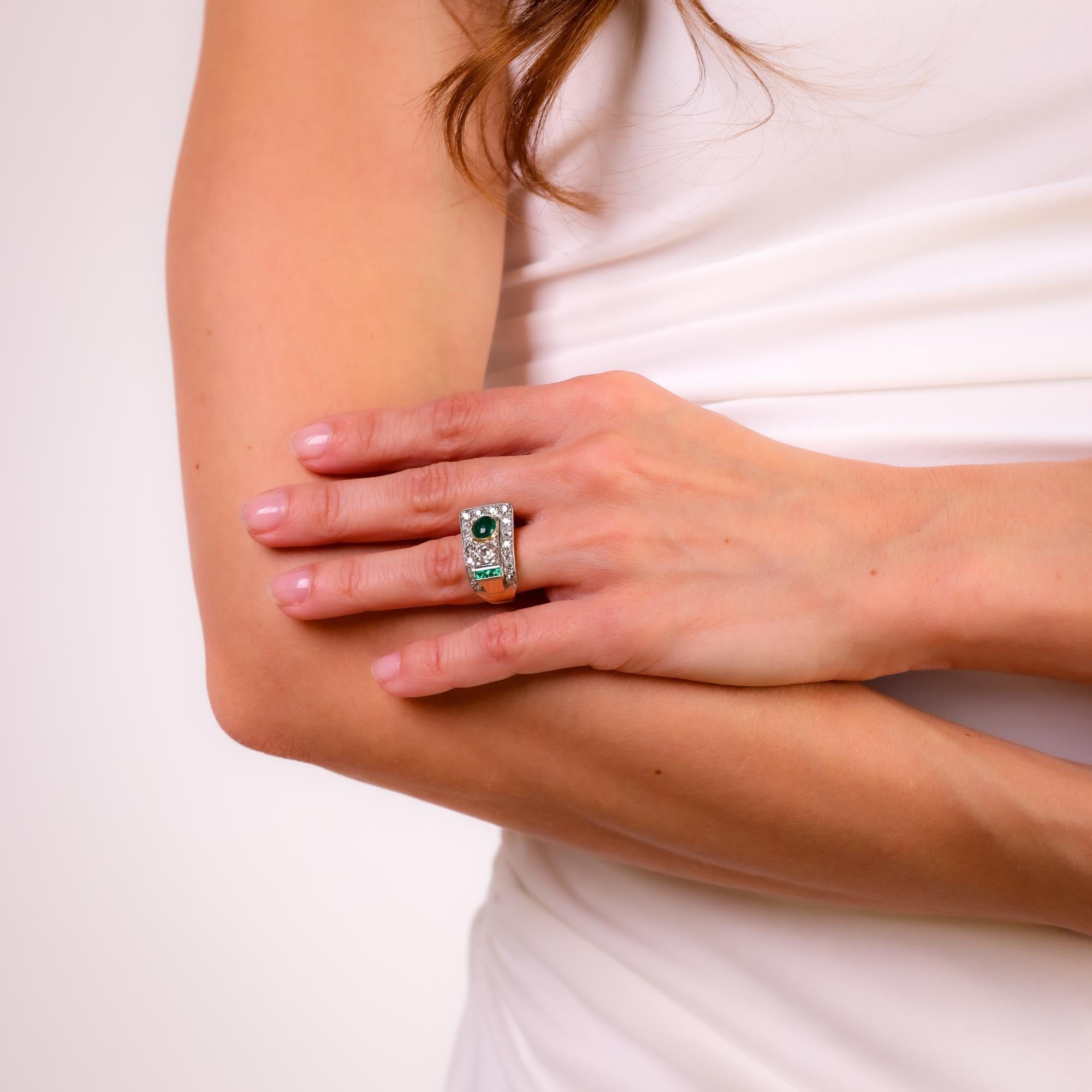 This Retro 1940s ring combines a luminous cabochon emerald, a sparkling old European cut diamond, and vibrant emerald accents in a striking gold setting.

Center stone: Cabochon cut emerald
Weight: Approximately 0.75 carats
Accent stone: Old