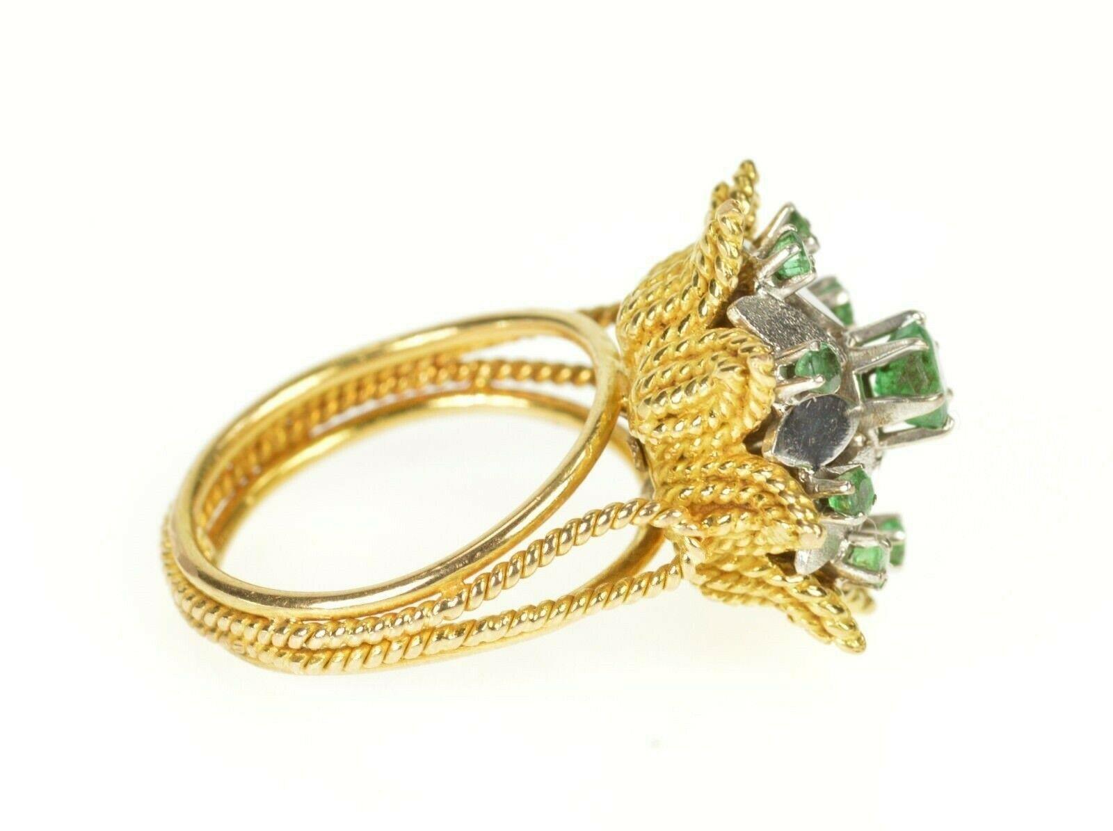 Item:  18K Retro Two Tone Emerald Floral Rope Cocktail Ring Size 6.25 Yellow Gold

Weight:  9.3g

Gem Stone:  8x=Emerald

Center Gem Stone:  1x=Emerald

Composition:  18k Gold Tested

Condition:  Estate:Good