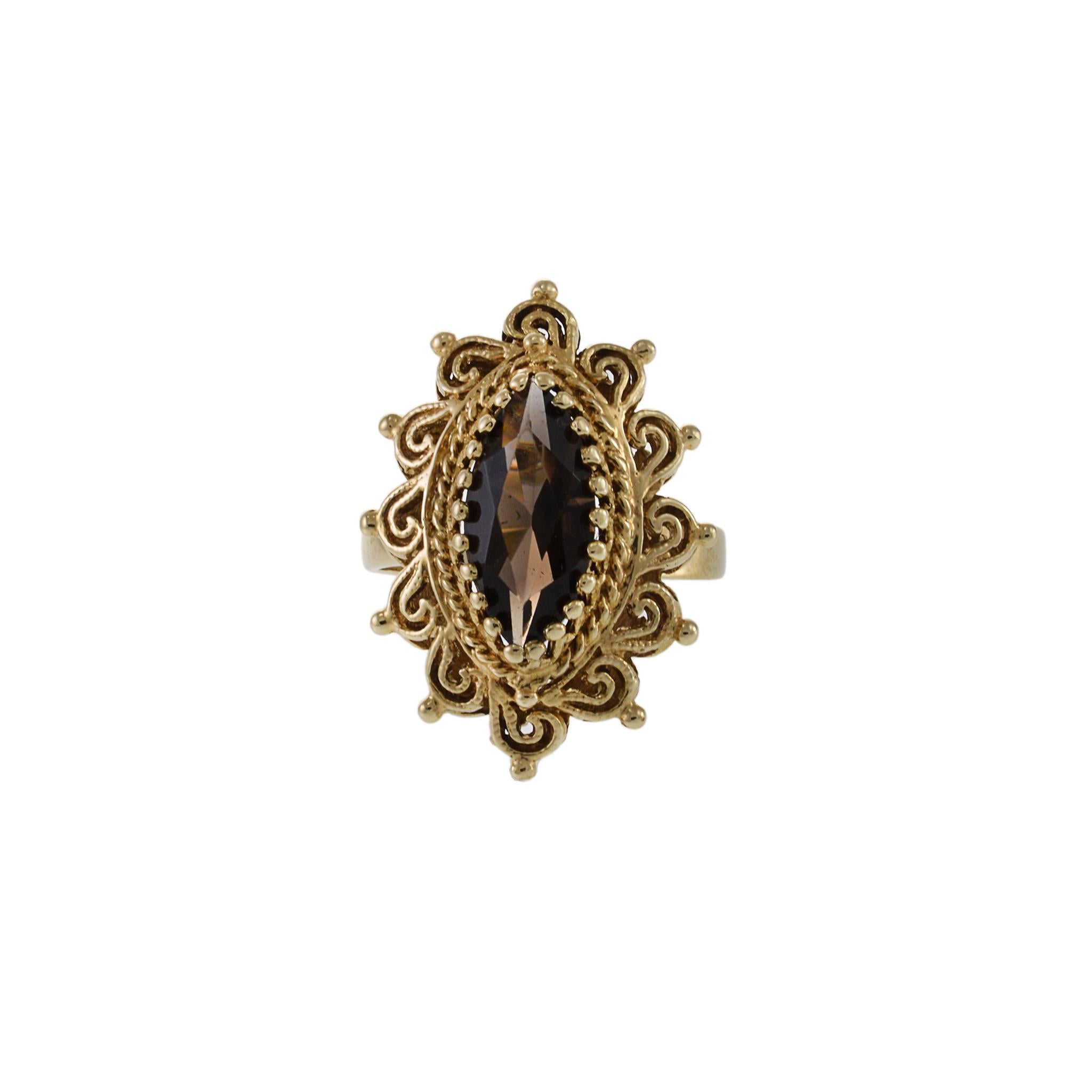 Steal the show with this luxurious Retro era 14KT yellow gold ring. Its marquise shape is perfectly complemented by a breathtaking 2.50CT marquise cut Smokey topaz, evoking a sense of old-world glamour. As if that weren't enough, the intricate