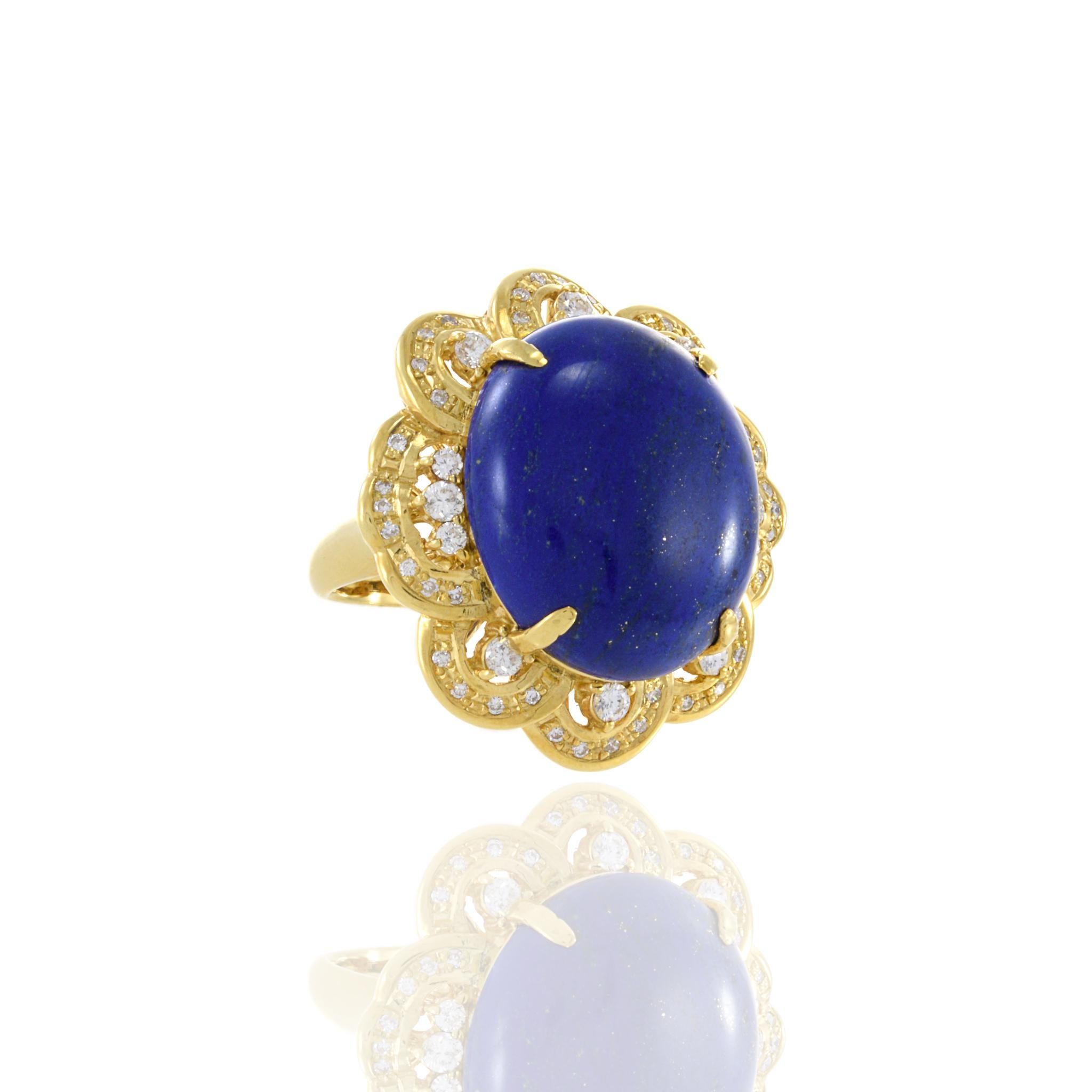 
This Retro Era 18KT Yellow Gold Lapis Lazuli and Diamond Cocktail Ring is an extraordinary testament to the allure and grandeur of vintage jewelry design. At its heart sits a magnificent cabochon cut natural lapis lazuli, its deep blue hues