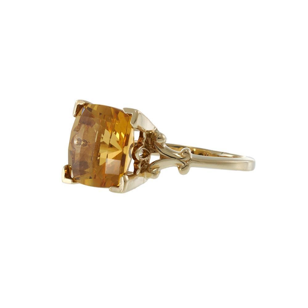 A bold expression of Retro-era glamour, this vintage ring features a 4.22 carat cushion-cut citrine with checkerboard faceting—delivering a warm golden glow with captivating light play. The gem is set in a 14KT yellow gold mount, its sculpted