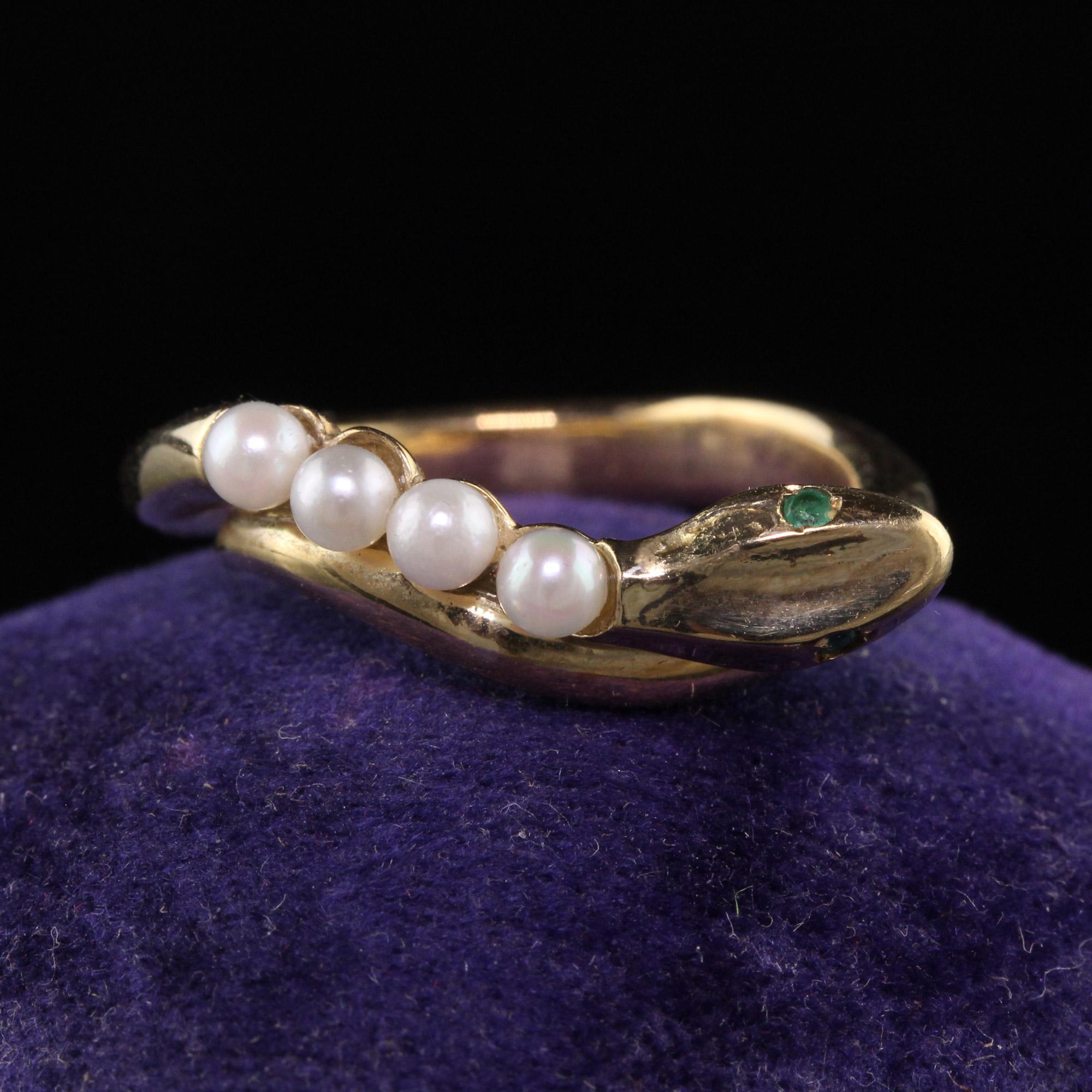 Beautiful Retro Estate 14K Yellow Gold Pearl and Emerald Snake Ring. This beautiful ring is crafted in 14k yellow gold. There are four round pearls on the back of the snake and has two emerald eyes. It is in great condition.

Item #R1329

Metal: 14K