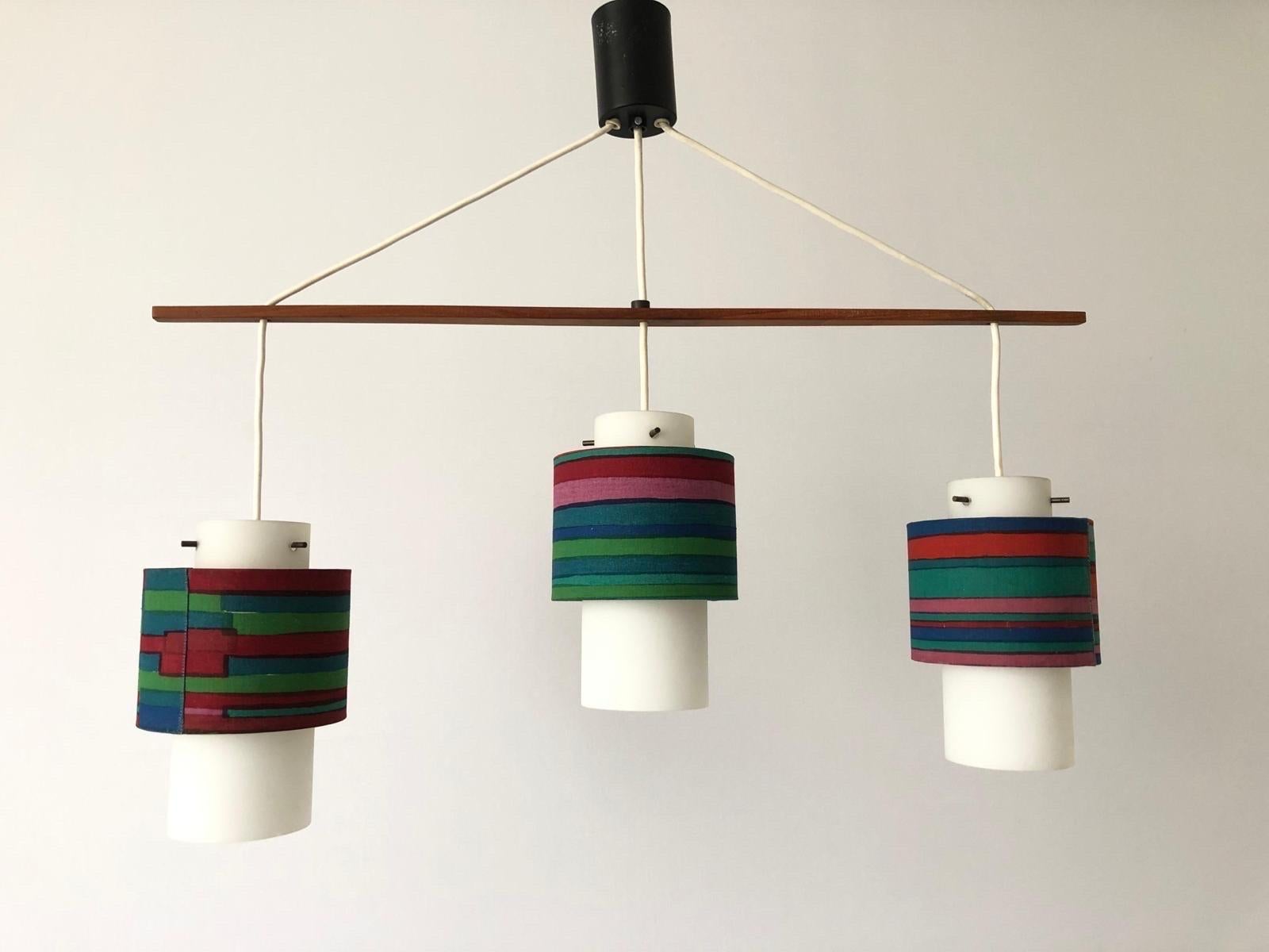 Retro Fabric Shade & Glass Triple Pendant Lamp, 1960s, Germany

This lamp works with 3x E14 light bulbs.

Measurements: 
Width and height: 68 cm and 60 cm
Shade diameter and height: 13 cm and 20 cm

