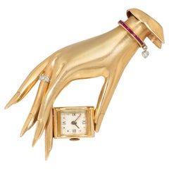 Retro Flato gold, ruby, and diamond hand brooch watch
