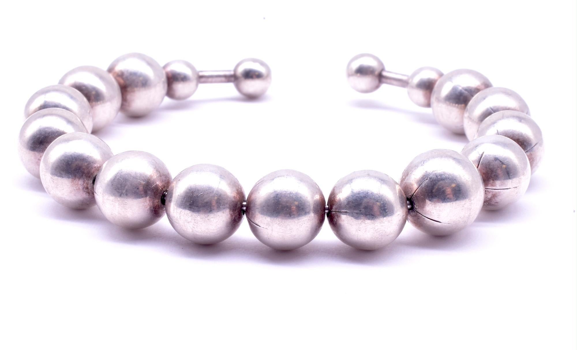 Retro set of graduated sterling balls mounted on a flexible wire that fits a small to medium sized wrist. A great bracelet to wear casually with others for a boho 