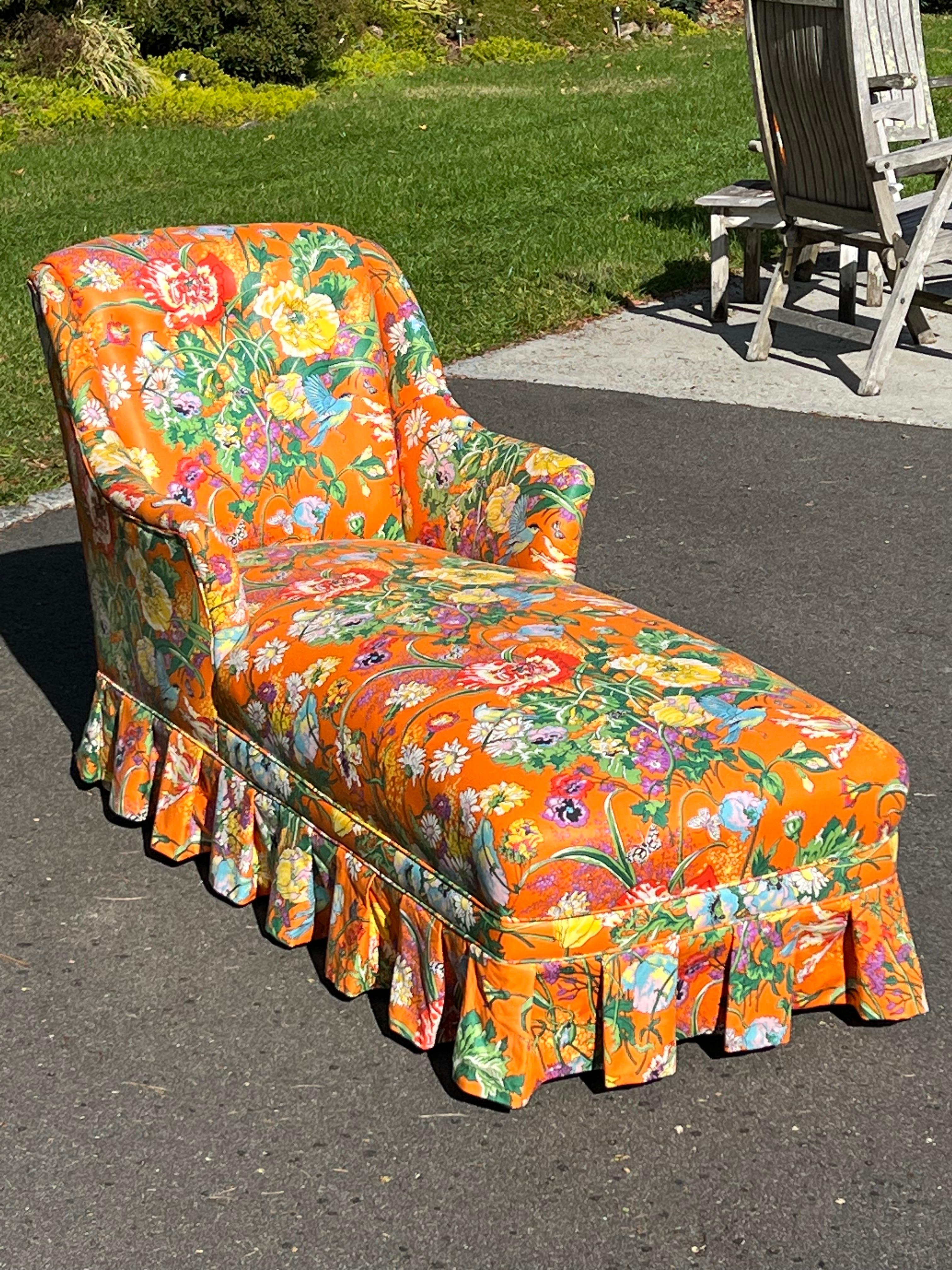 Retro Floral Chaise Lounge in Orange. Immaculate condition and amazing fabric design to this reclining beauty. Elegant skirted base with piping and wooden feet. This is the type of piece that you decorate a room around. Perfect for a dressing room
