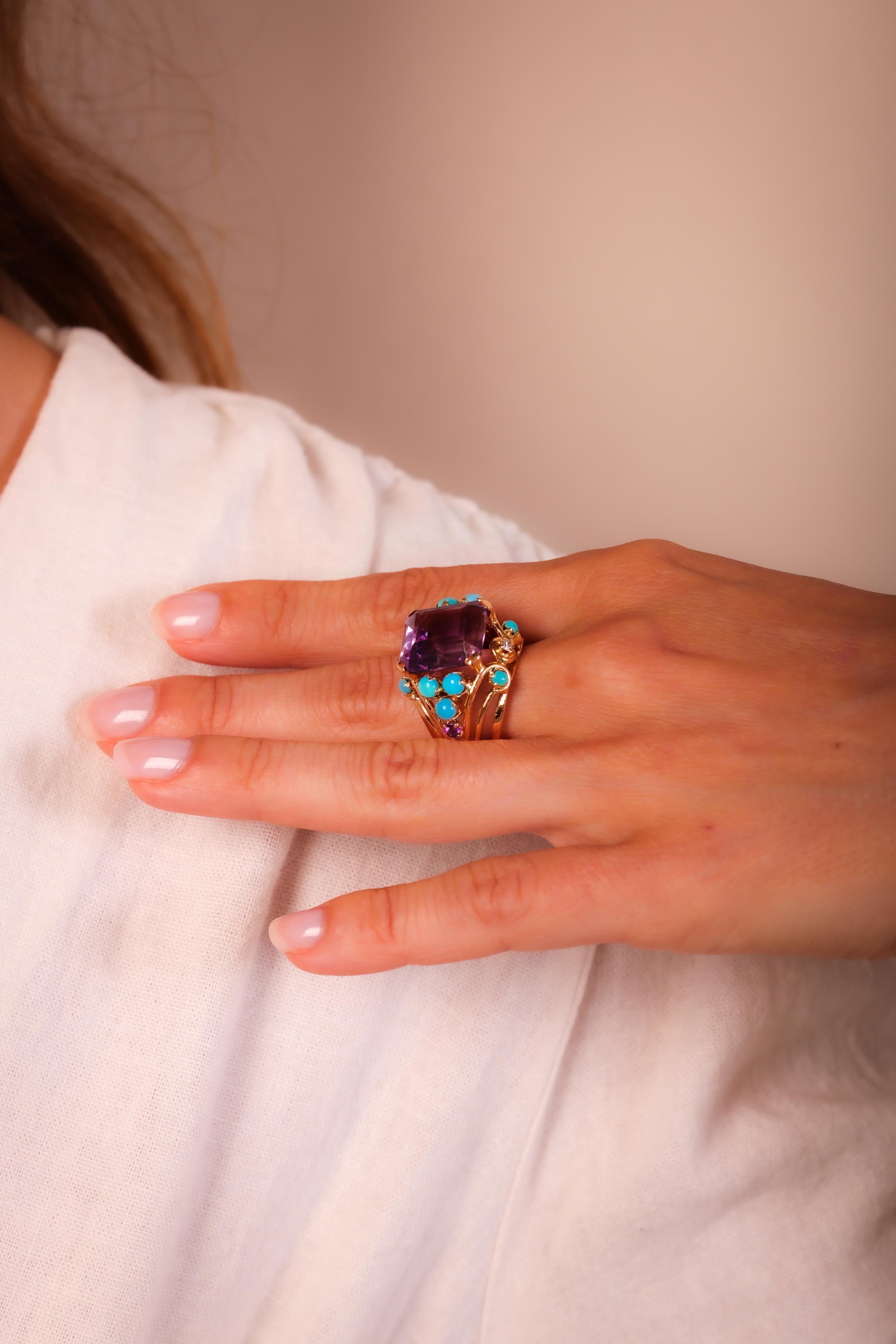 Center Stone: Emerald Cut Amethyst
Weight: Approximately 11 Carats
Accent Stone: 10 Cabochon Cut Turquoise
Accent Stone: 2 Single Cut Diamonds
Weight: Approximately .10 Carats
Color: H
Clarity: VS
Metal: 18K Yellow Gold
Era: Retro
Circa: