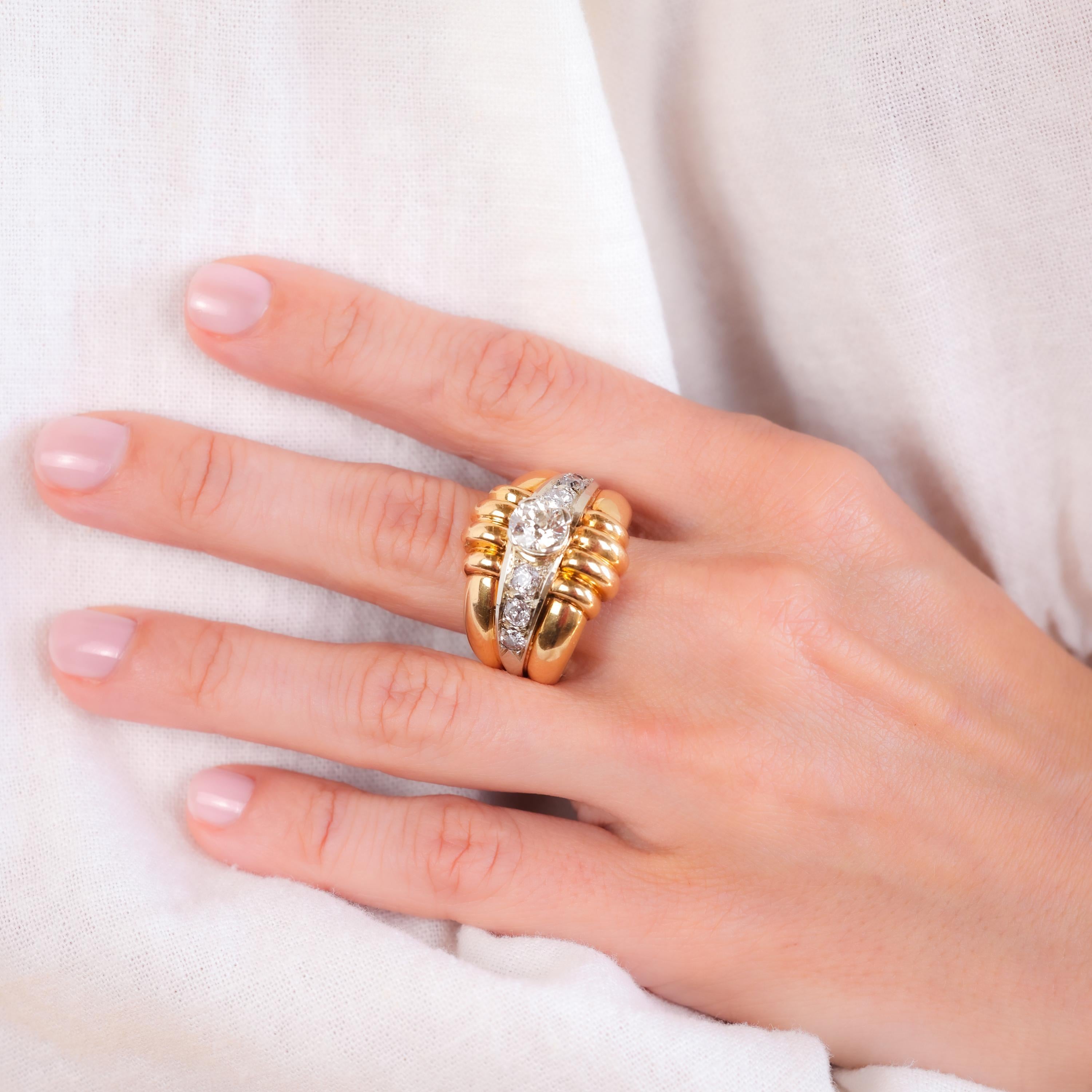 Center Stone: Diamond
Cut: Old European
Weight: Approximately 1.3 Carats
Color: H
Clarity: SI
Accent Stone: 6 Diamonds
Cut: Old European and Single
Weight: Approximately 0.8 Carats
Color: F-G
Clarity: I1
Metal: 18K Yellow Gold
Era: Retro
Circa: