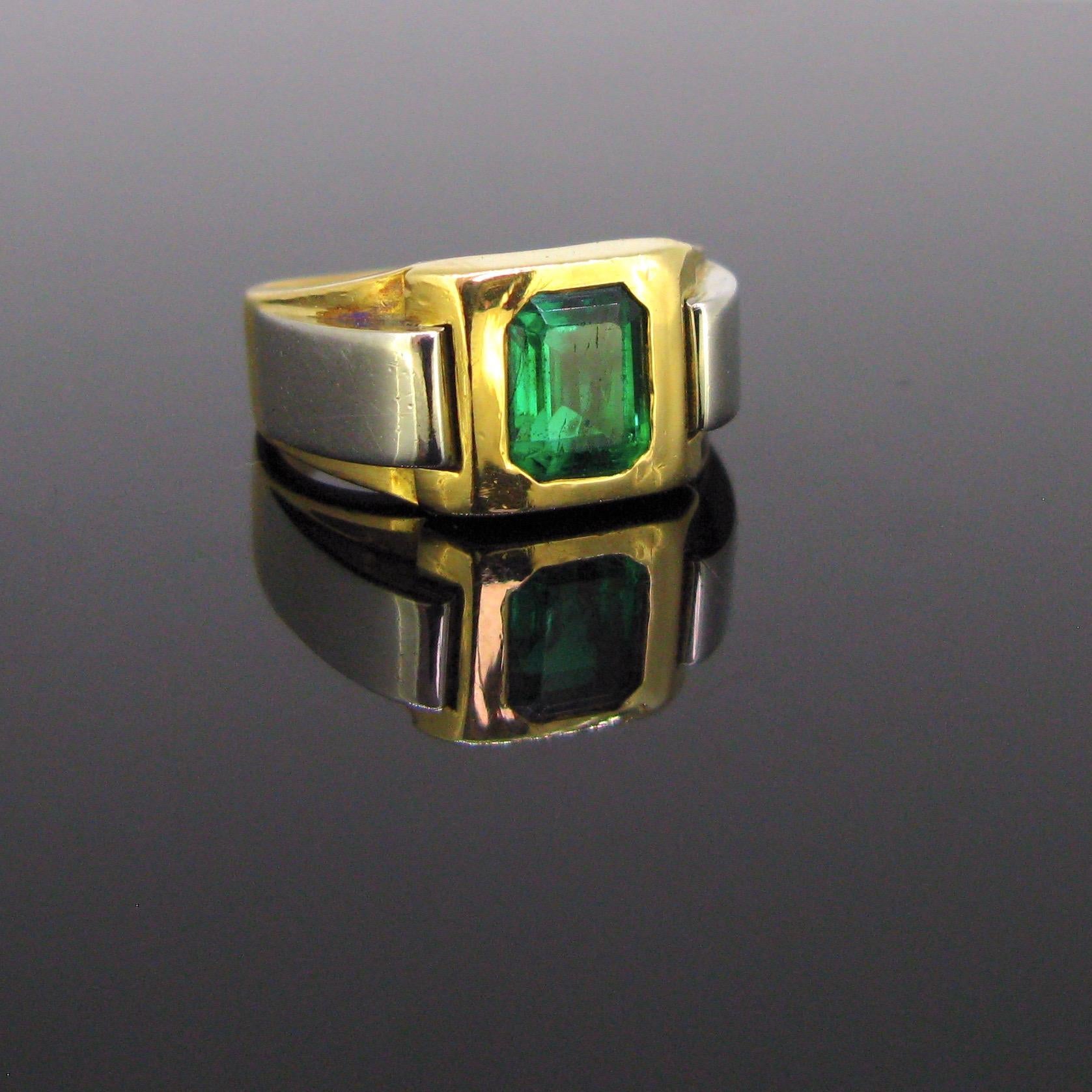 This ring has a beautiful geometric design. It is set with a vibrant deep green emerald weighing around 1.4ct. It has been tested by the GCS lab - the emerald is from Afghanistan and has indication of moderate clarity enhancement. The shoulders of