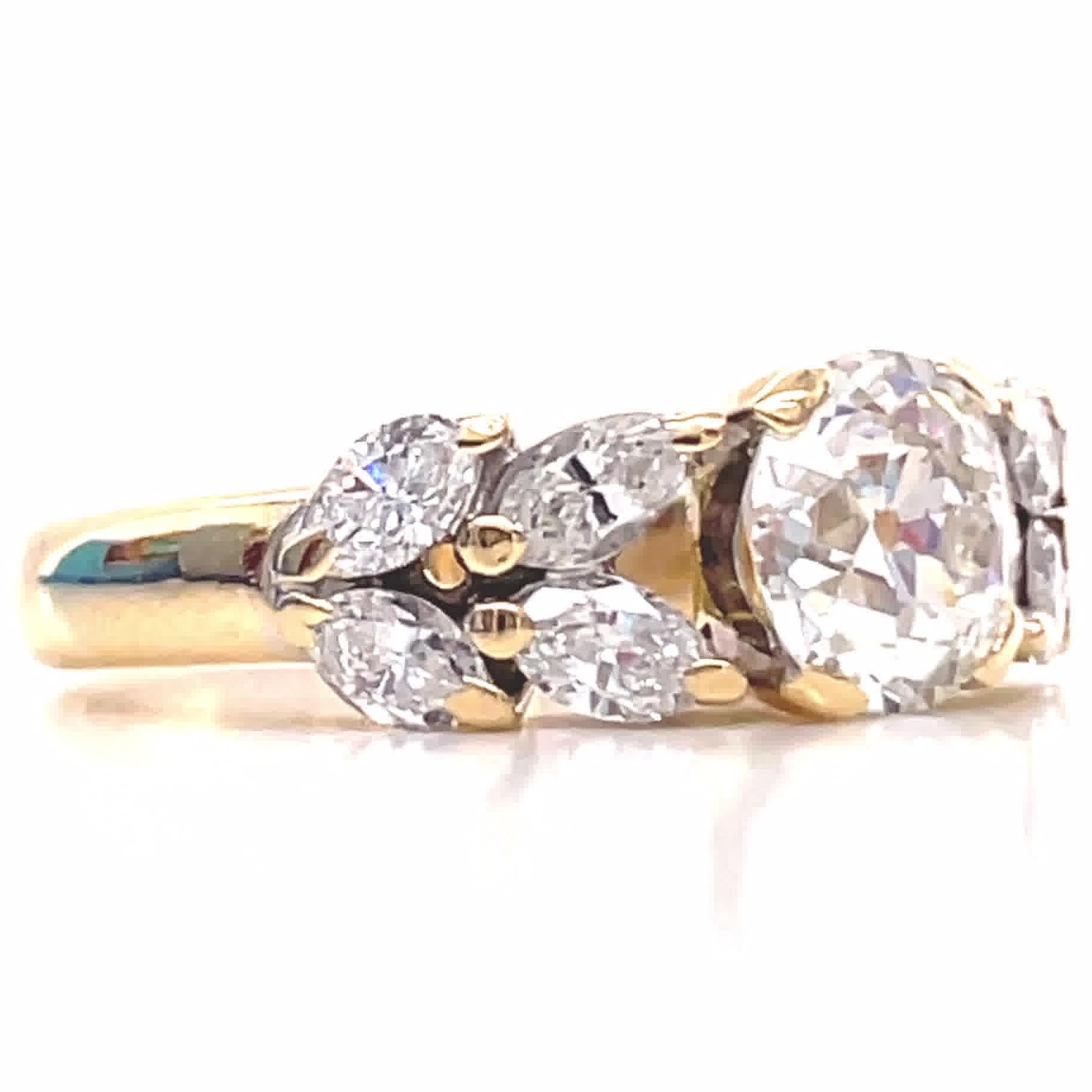 If you are a fan of yellow gold and diamonds, consider this Retro French GIA 1.77 carat Old European Cut Diamond 18k Gold Ring. Classic and timeless, this ring will serve you well and will attract admirers from all corners. The marquise cut diamonds