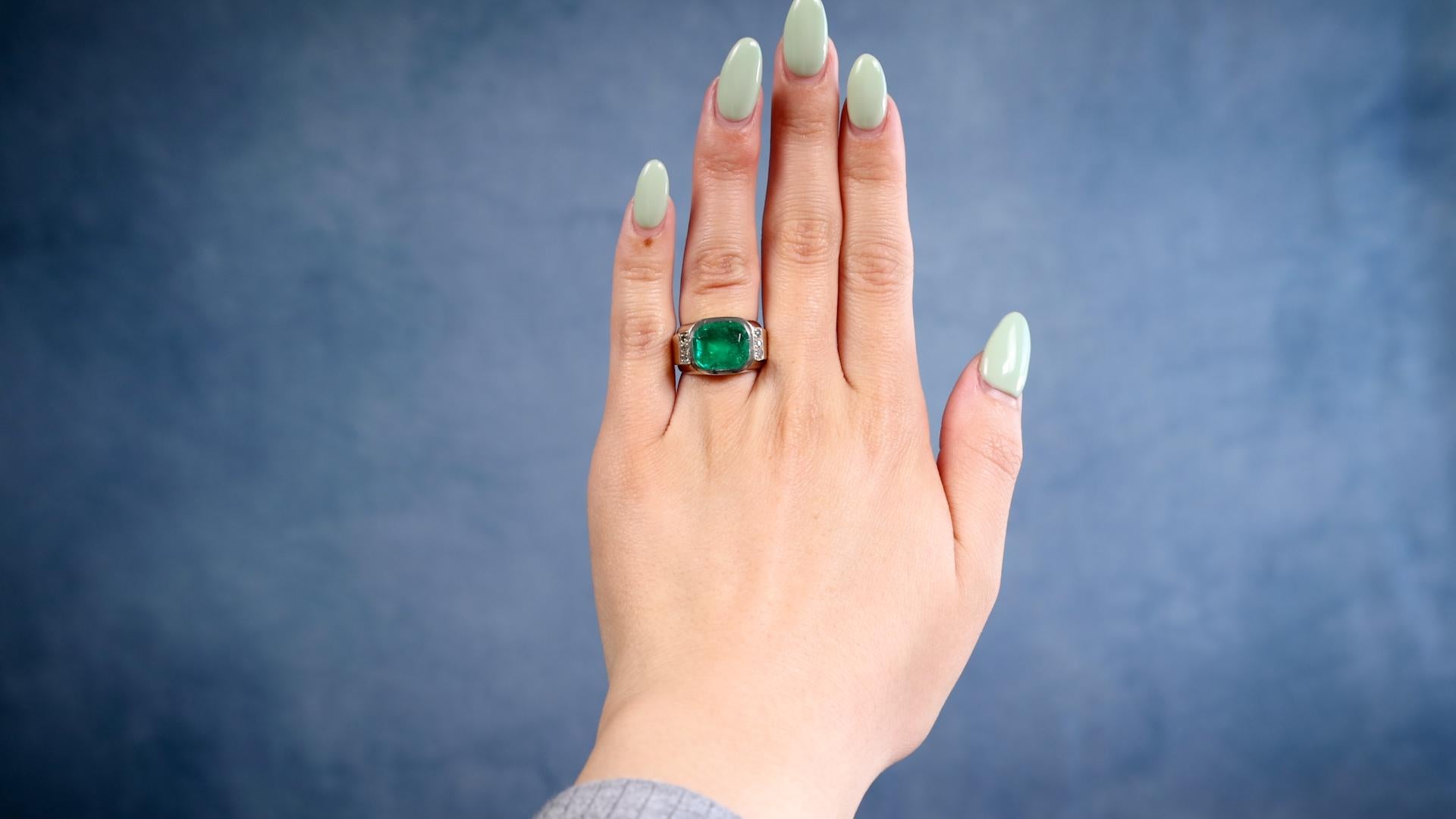 One Retro French GIA Colombian Emerald 18k Yellow Gold Ring. Featuring one GIA cushion cut emerald weighing approximately 4.00 carats, accompanied by GIA #6237221154 stating the emerald is of Colombian origin. Accented by six single cut diamonds