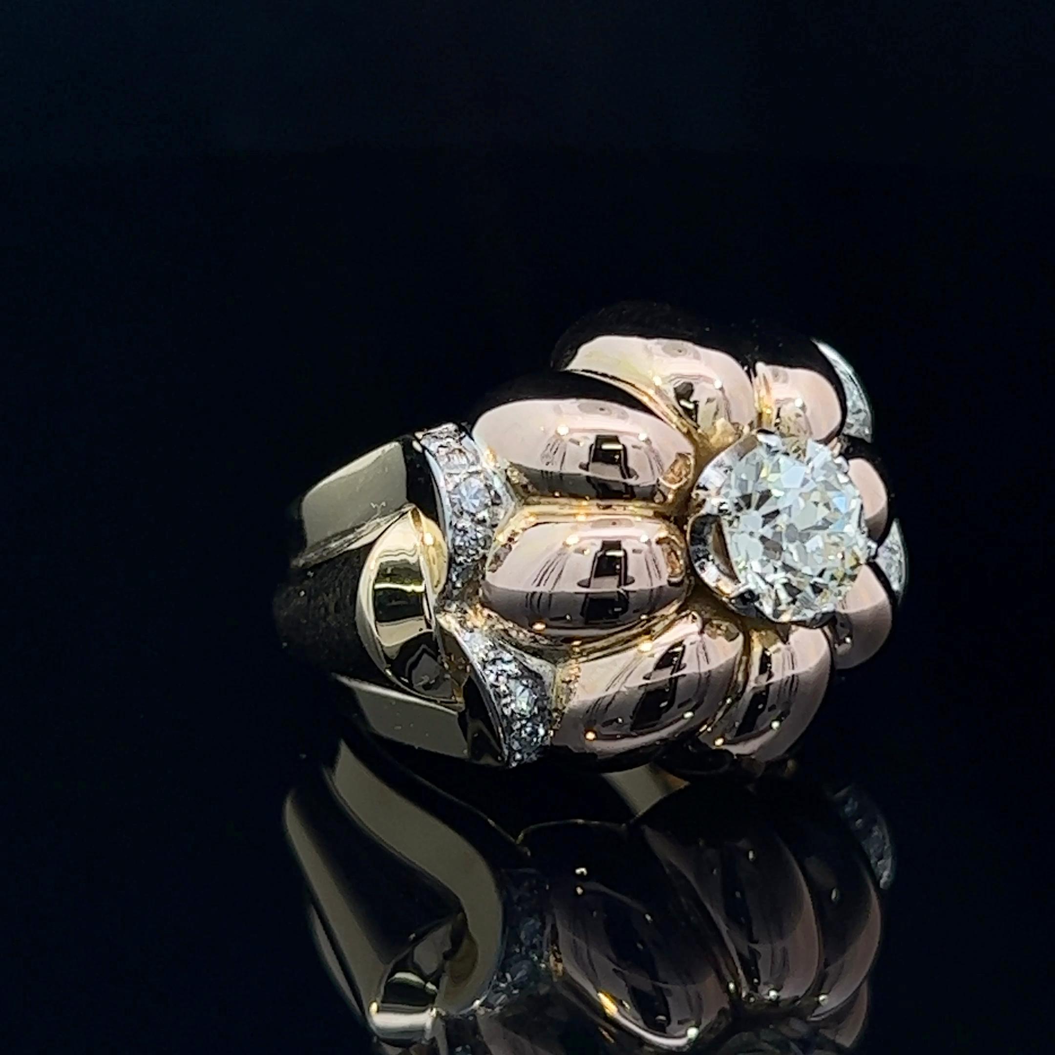 One French made diamond set floral ring. Comprising of a hand-crafted rose gold raised ribbed domed as the flowers petals. An old cut diamond is the feature of the centre of the flower.  To complete the piece, the flower sits on a yellow gold raised