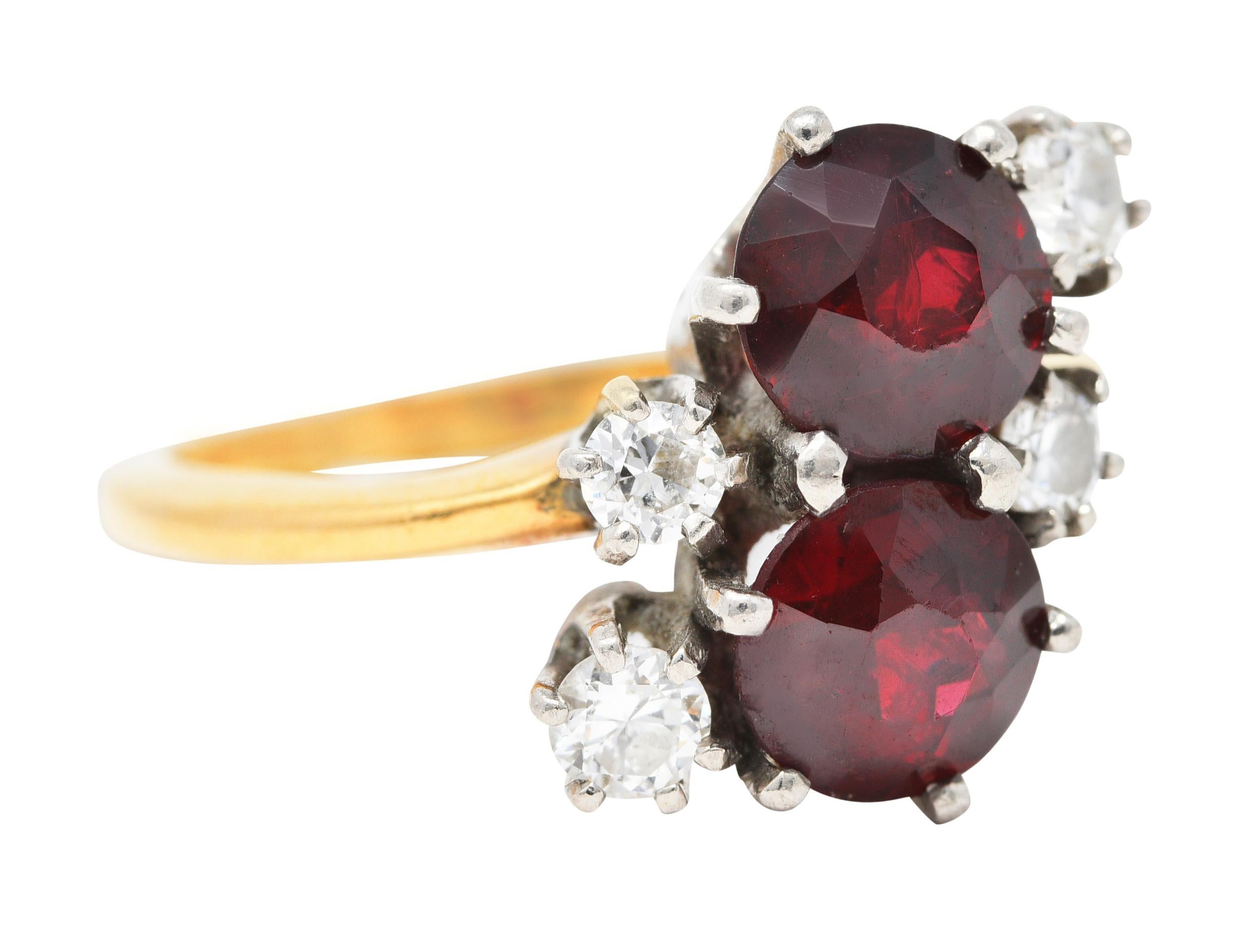 Designed as a gemstone cluster featuring two round cut garnets in the Toi et Moi style. French translated as 'You and Me'. Very well matched in rich red color while each measures approximately 6.1 mm. Accented by transitional cut diamonds weighing