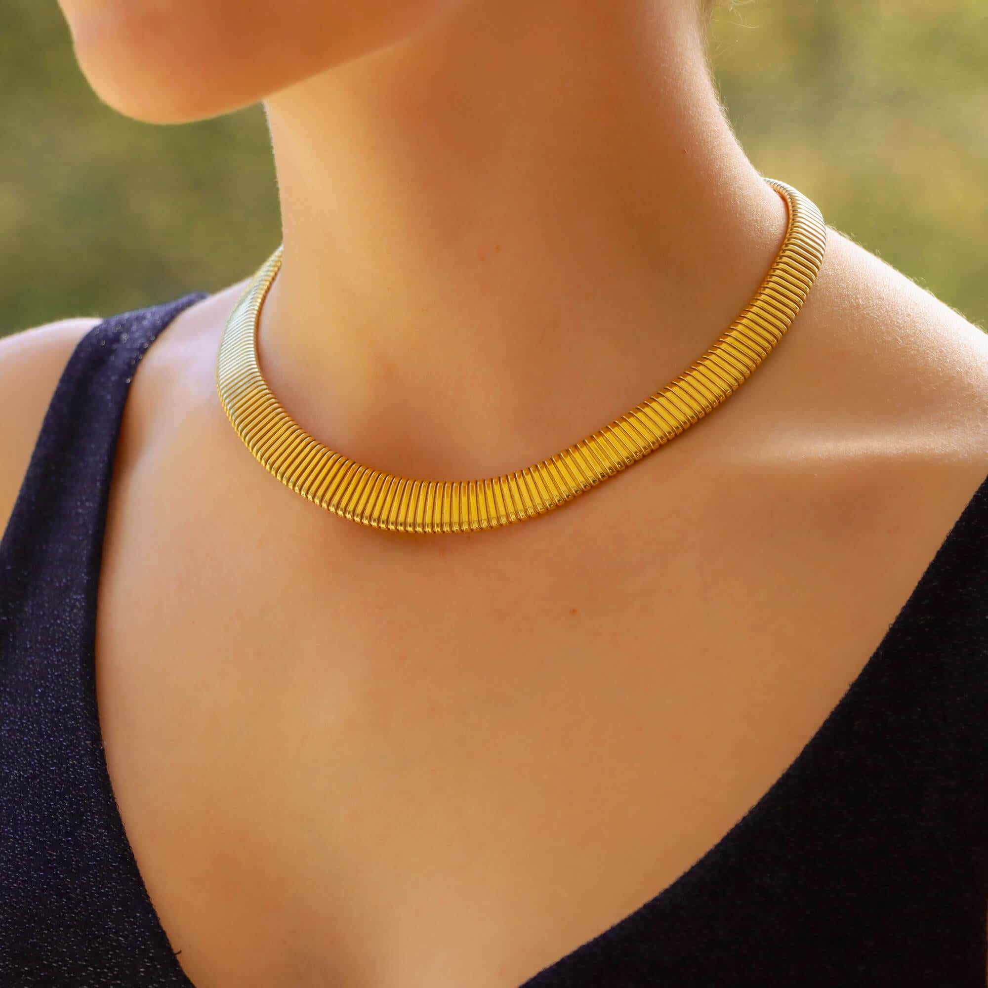 A beautiful vintage gas pipe collar necklace set in 18k yellow gold. 

Once on the necklace truly comes to life! Due to the design, the piece sits lovely and flat on the neck making it a perfect piece to wear for every day. The gold ‘ridges’ catch
