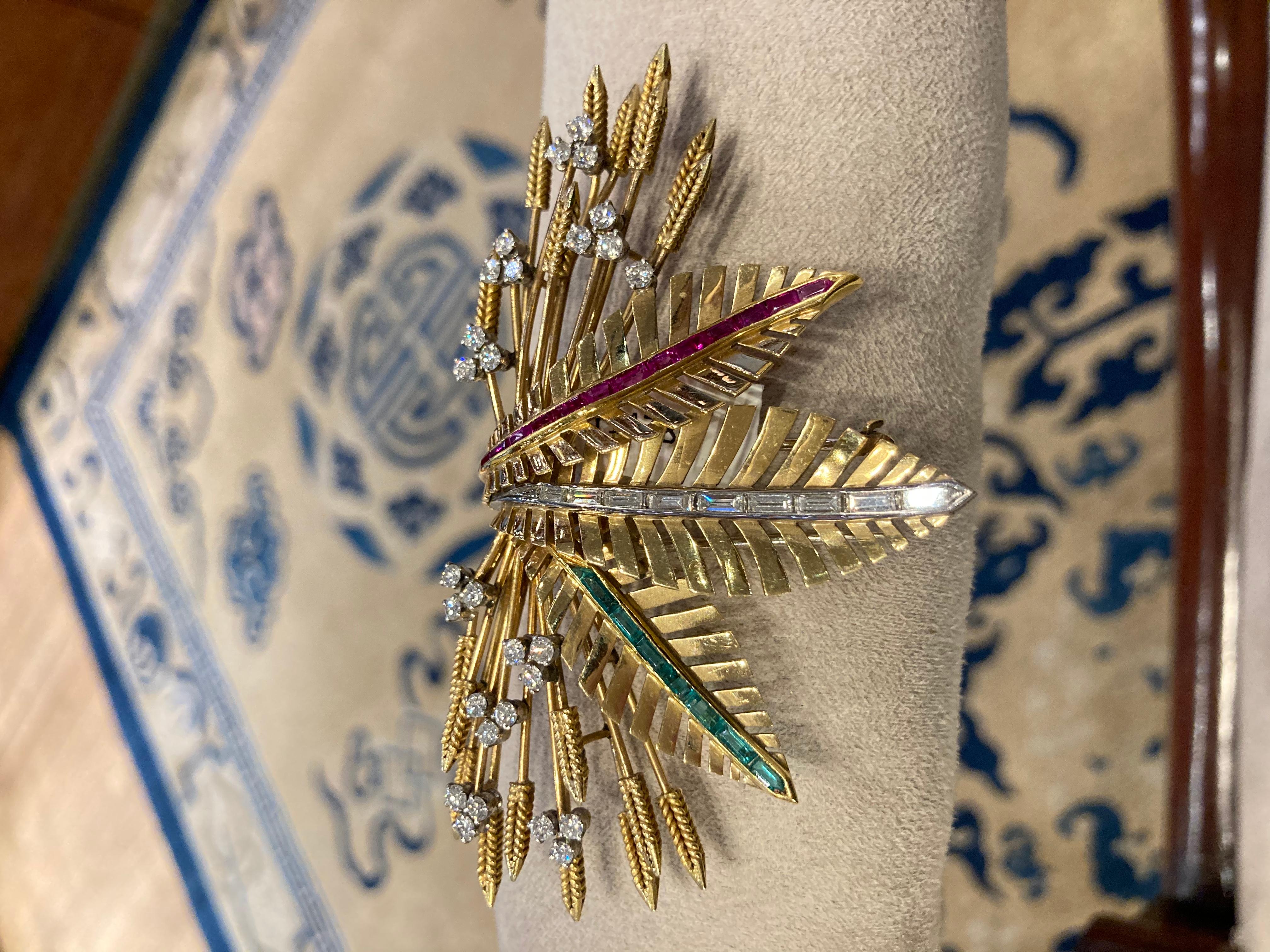 A beautiful retro clip brooch of wheat design,  in 18 karat yellow gold with diamonds, rubies, and emeralds. Circa 1940.