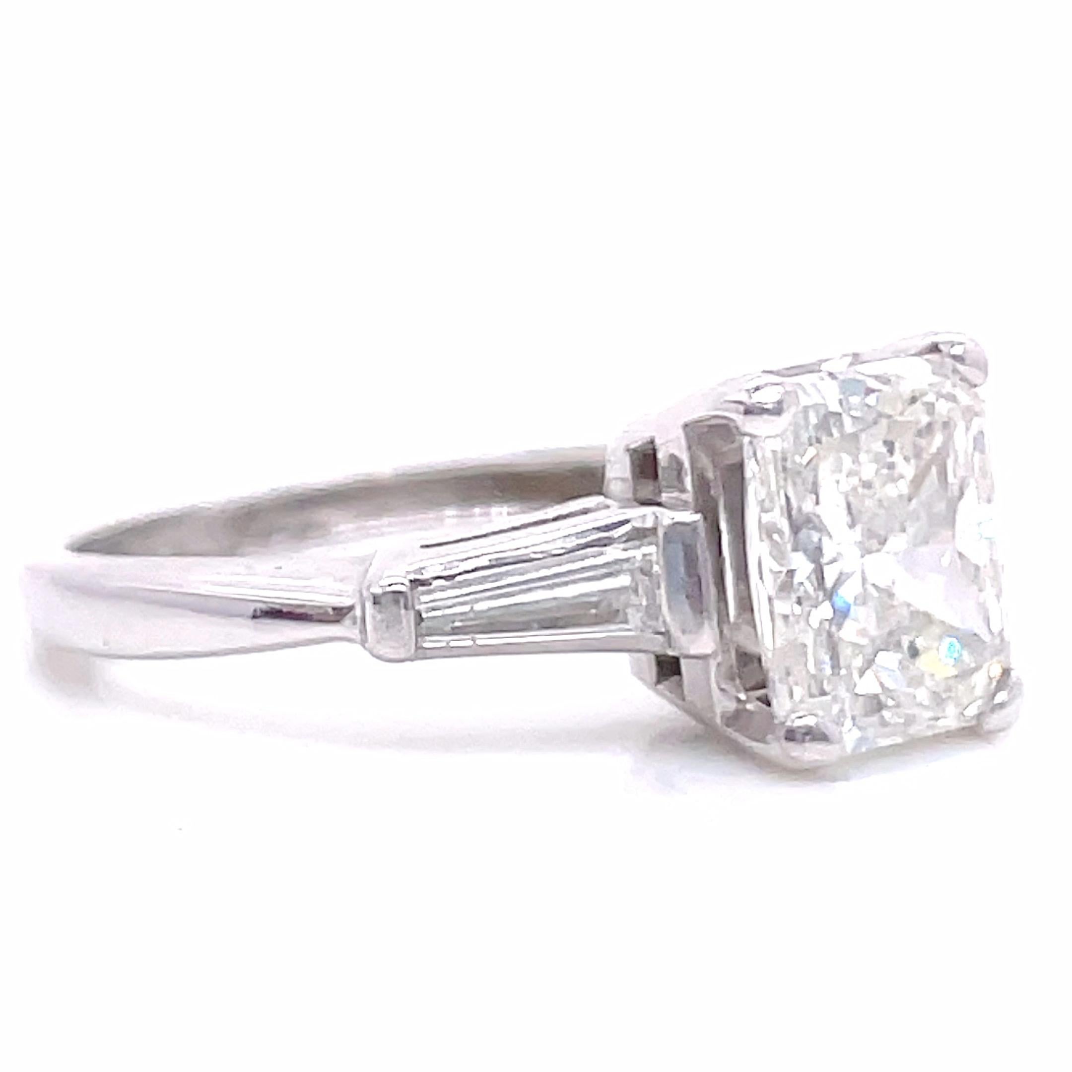 Your perfect, elegant vintage engagement ring that you can wear every day. You can celebrate love and beauty daily. The main stone is a GIA certified radiant cut weighing 1.80 carat, J color, SI1 clarity (#5211430790). Accented by 2 tapered
