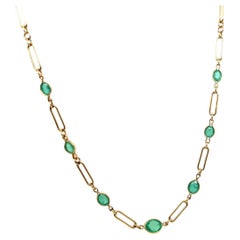 Retro Gold 1 Carat Natural Green Oval Emerald Necklace, Circa 1970