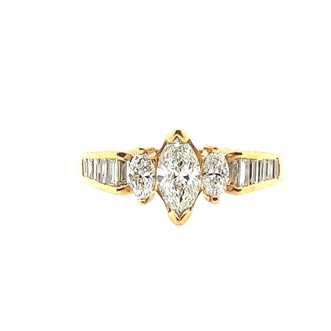 
Stunning 14k Yellow Gold Natural Marquise and baguette diamond engagement ring. 

The 0.45 carat center stone measures approximately 7.5x3.8m, is approximately G in color and vs2 in clarity. 

The center is flanked with 2 natural marquise diamonds,
