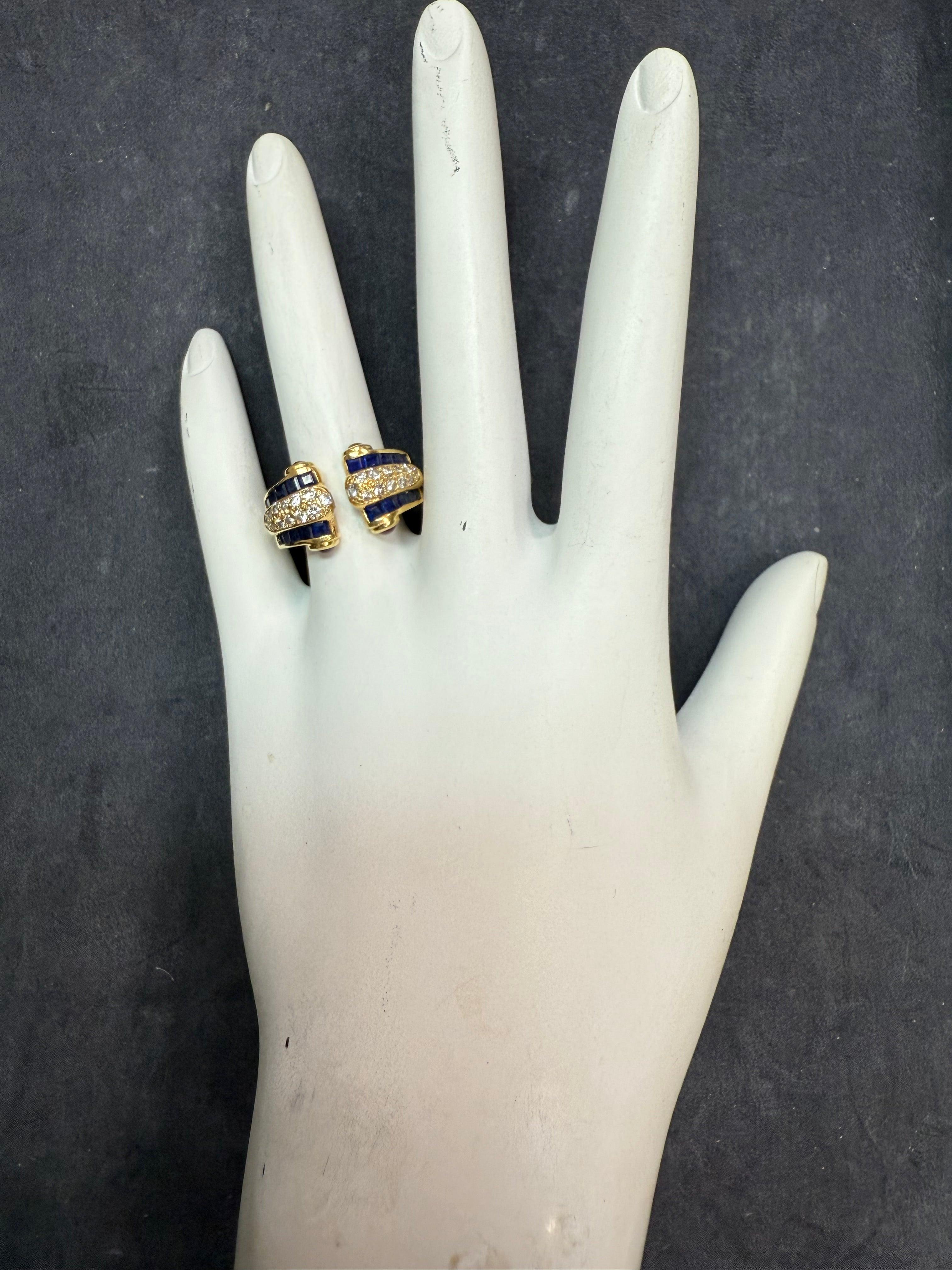 Retro 18k yellow gold statement ring showcasing approximately 1.5 carats of natural colorless diamonds, accented by twenty baguette-cut natural blue sapphires and four richly hued cabochon rubies. 
Elegantly designed, the ring measures 12 mm at the
