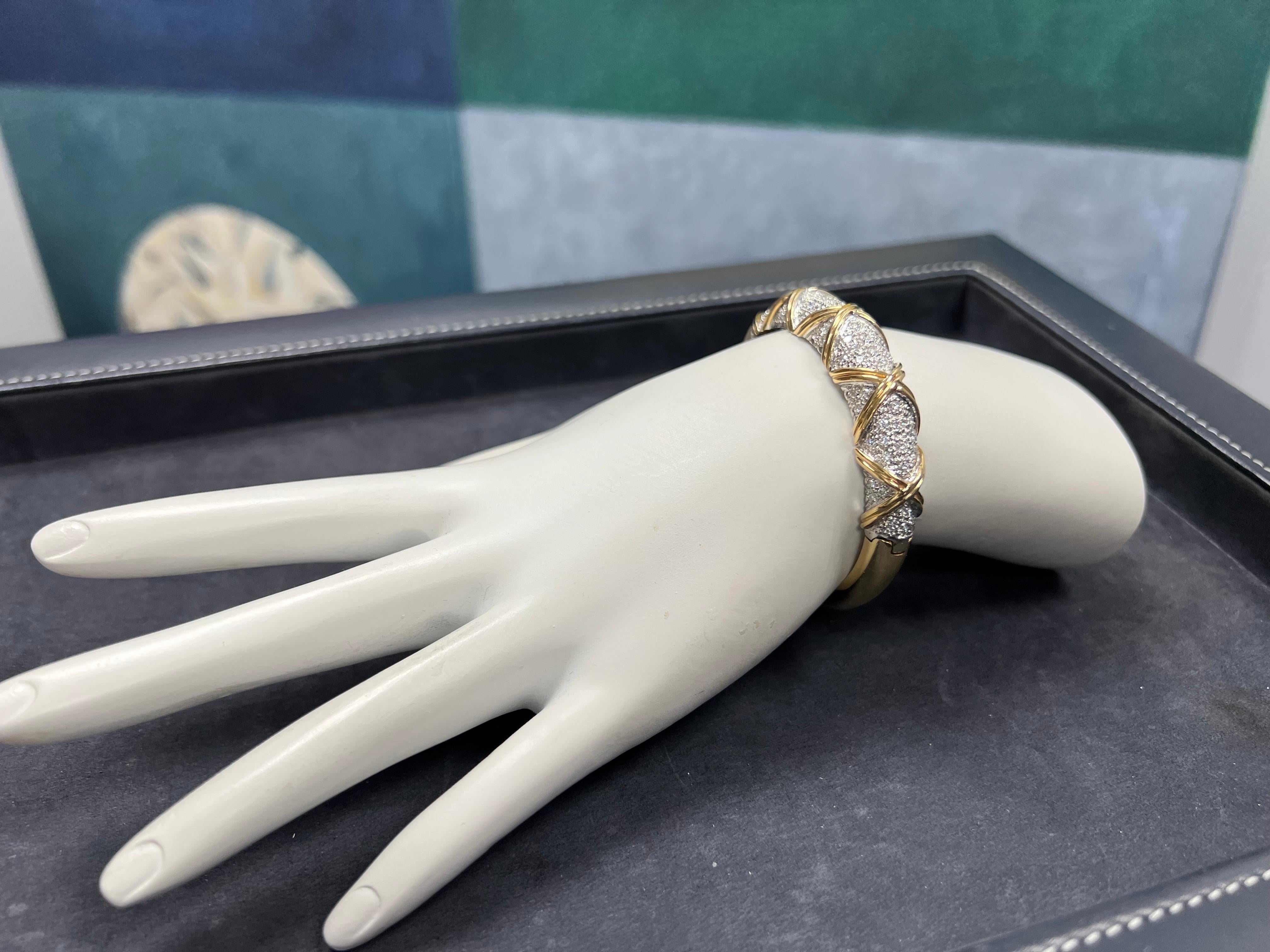 
A magnificent 2.50 Carat Natural Round Brilliant colorless diamond bangle. The piece is mounted in 18k Yellow Gold and is set with 104 round brilliant diamonds, approximately E-F in color and VS-VVS in clarity. 

The piece weighs 35.8 grams total