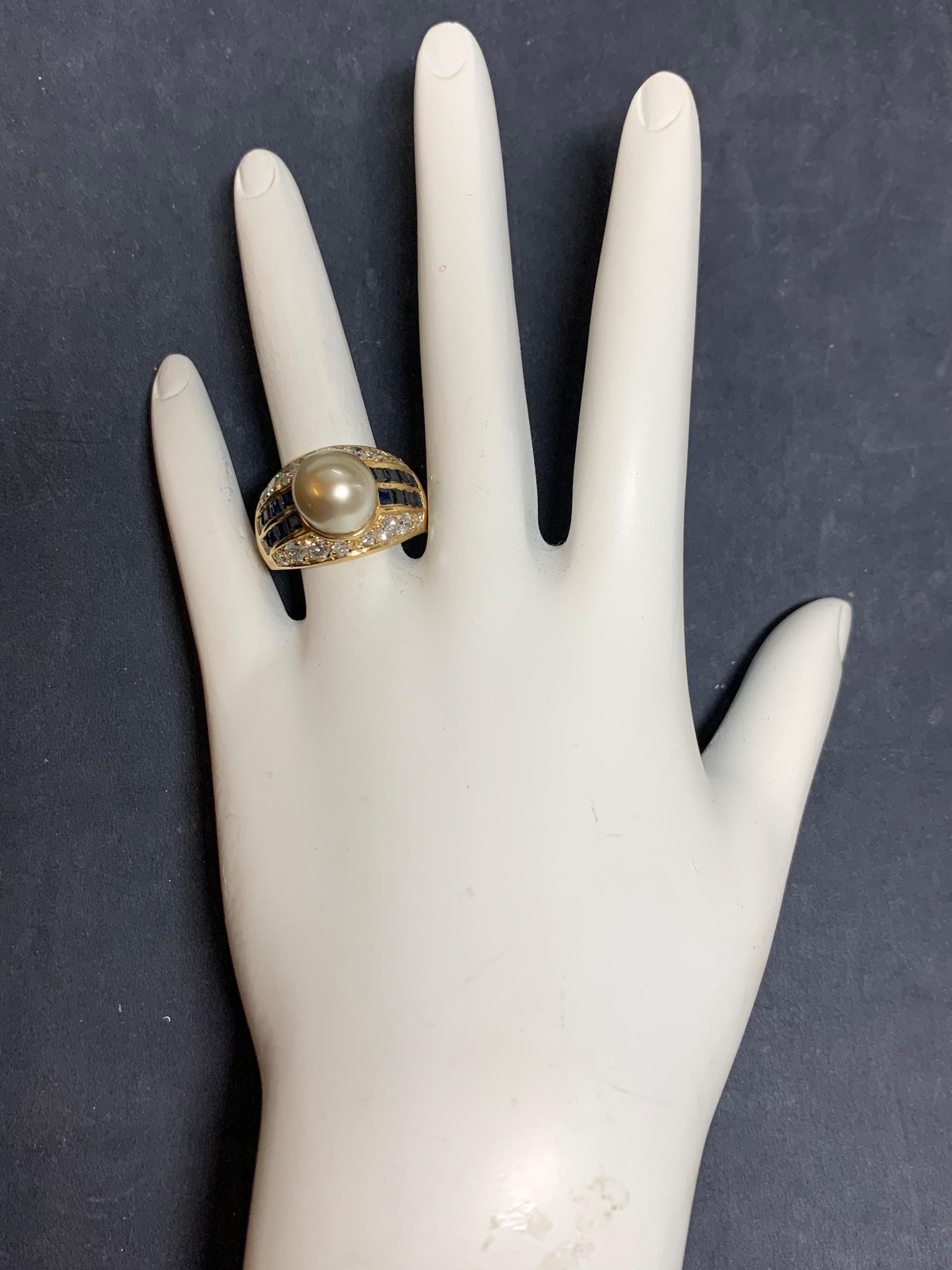 Retro 14k Yellow Gold Ring set with 2.50 Carat (approximate) Natural Diamonds, Sapphires & a 10mm Pearl.

The ring is set with 16 natural colorless VS round brilliant diamonds weighing approximately 1 carat. It is also set with 16 natural square