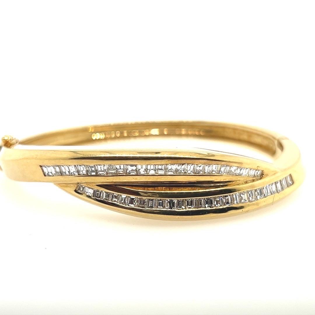 A magnificent 3.57 Carat Bangle mounted in 14k Yellow Gold. The piece is set with 51 Baguette diamonds approximately F in color and VS in clarity. 

The weight is 40 grams total and the inner rim is approximately 6.75