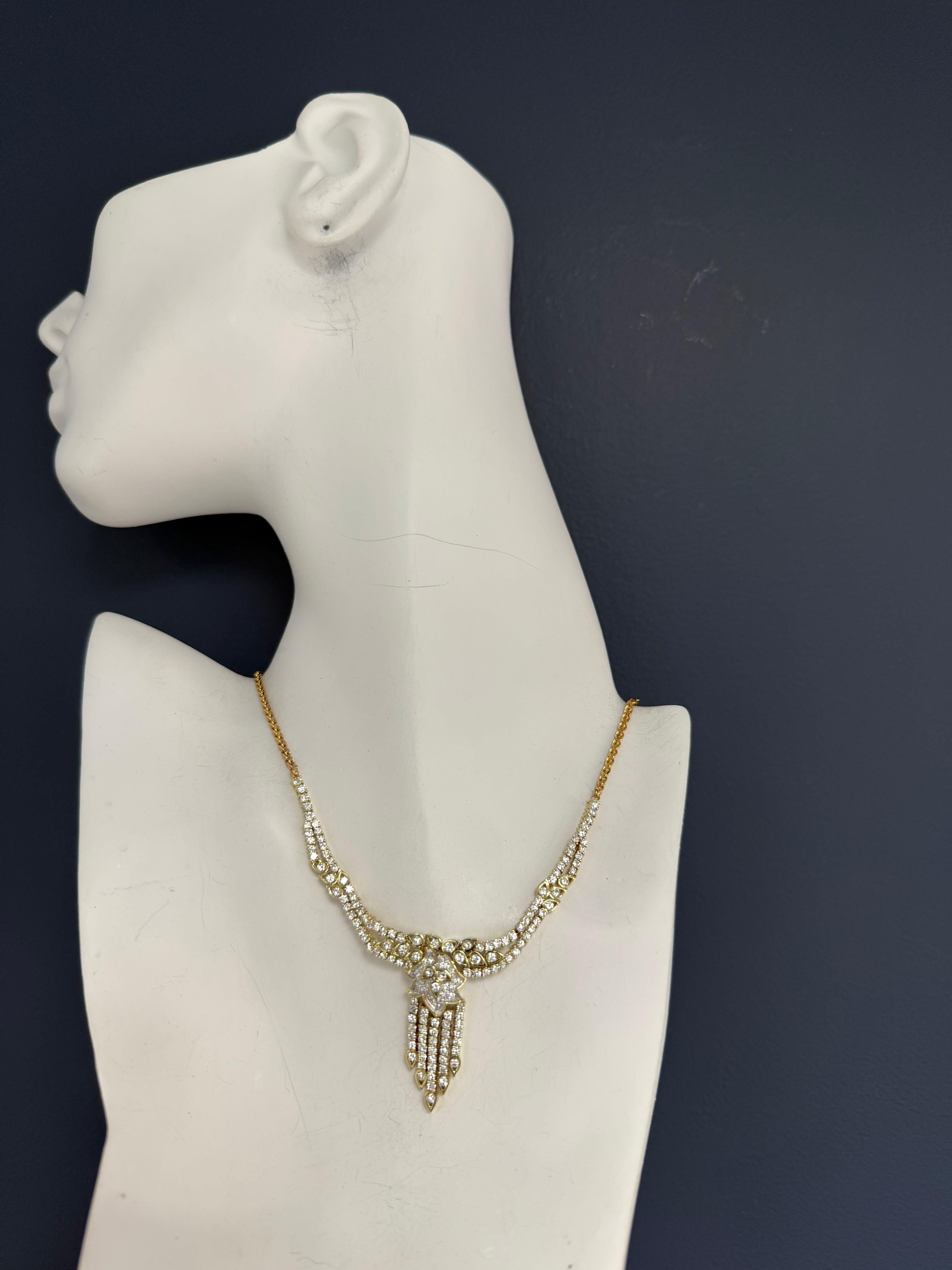 One magnificent 14K yellow gold and natural diamond necklace, measuring 16 1/2 inches in length and weighing approximately 23.4 grams. This stunning piece is set with approximately 154 round brilliant diamonds, totaling an estimated 5 carats. The
