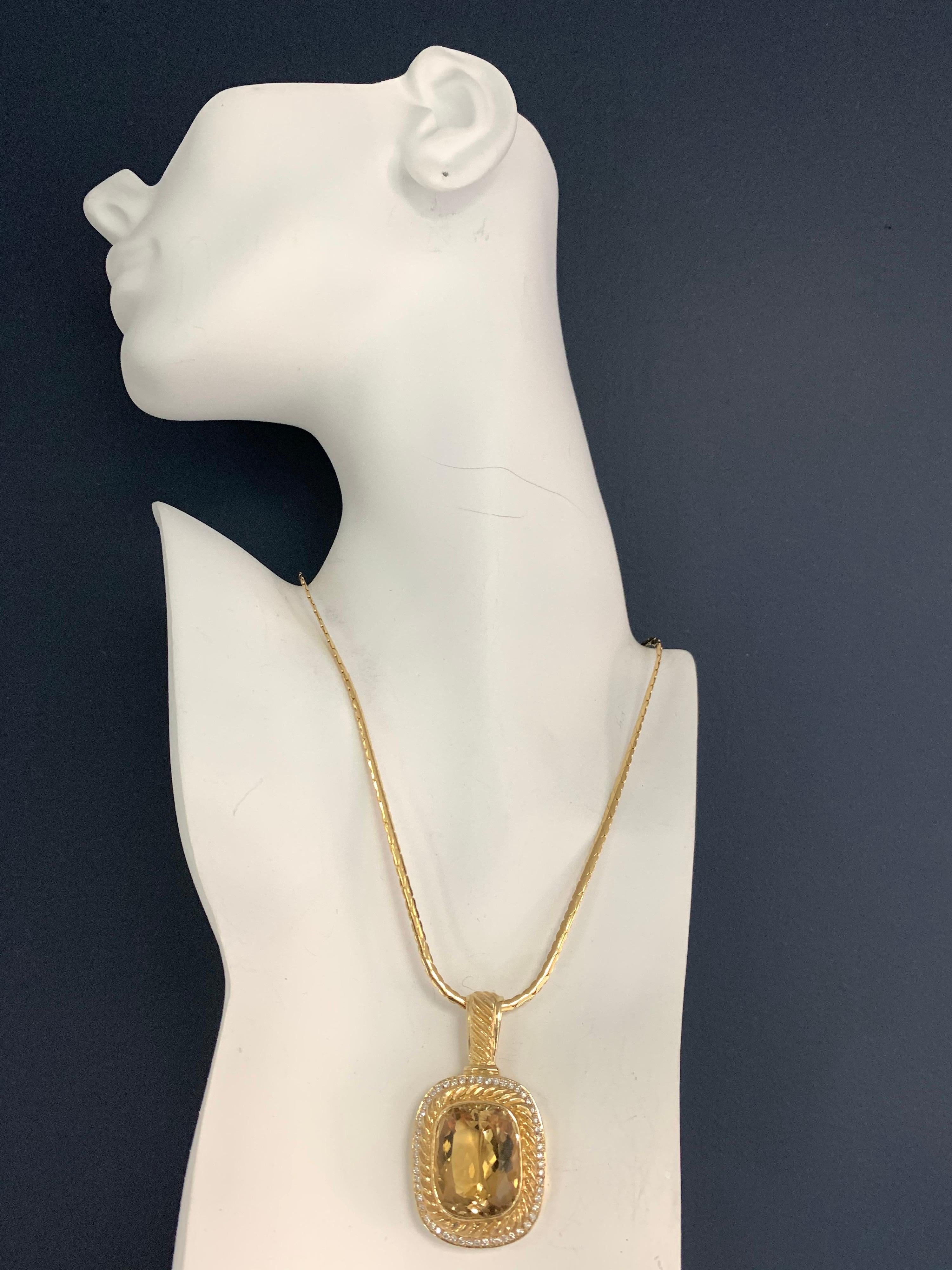 Retro 14K Gold Pendant (27.7 grams) set with an approximately 50 carat Natural Cushion Citrine Quartz measuring 24x20x11.9mm.

Surrounding the stone are 56 Natural Round Brilliant Diamonds approximately 0.65 carats, F in color and VS-SI in clarity.