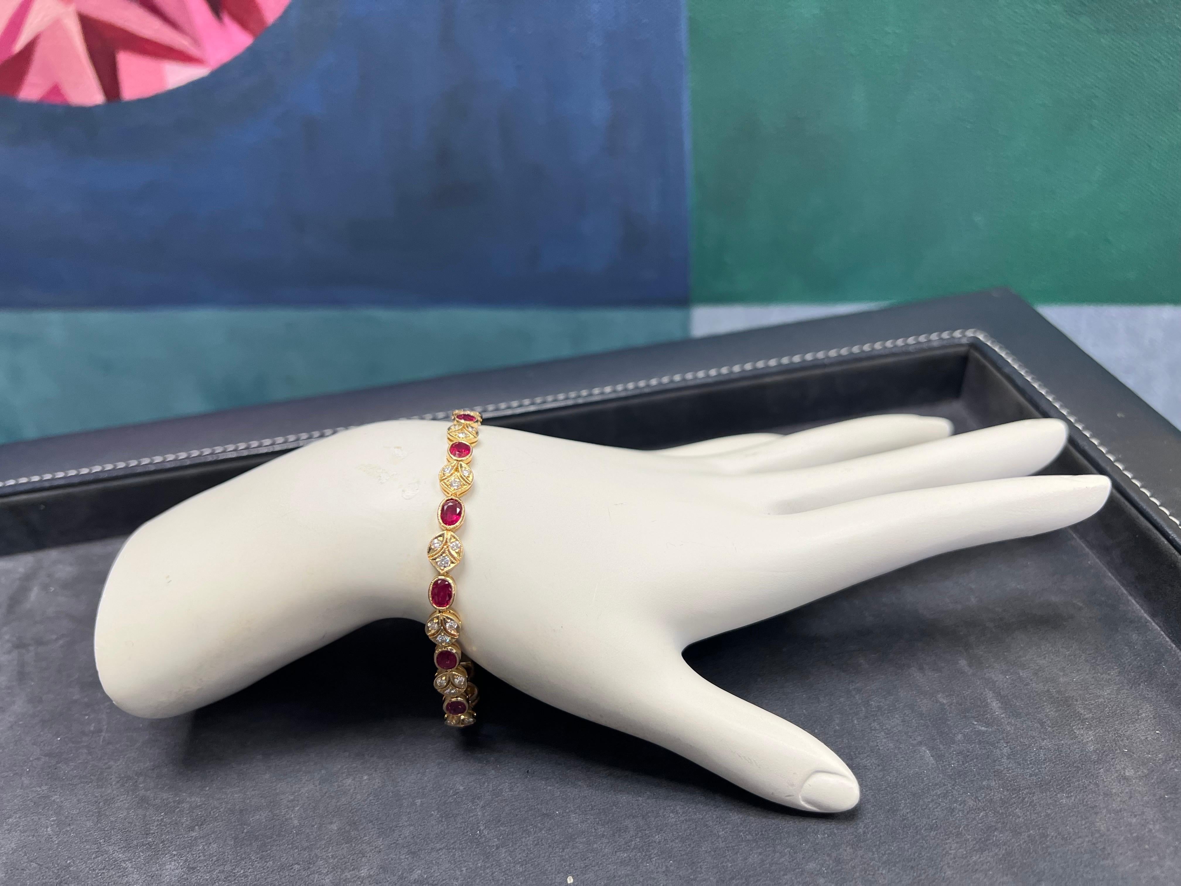A Magnificent 5.46 carat 18k Yellow Gold Natural Ruby and Diamond Bracelet. 

The piece is set with 13 oval natural rubies weighing 4.55 carats, along with 39 natural rounds weighing 0.91 carats. 

The length is just over 6.75