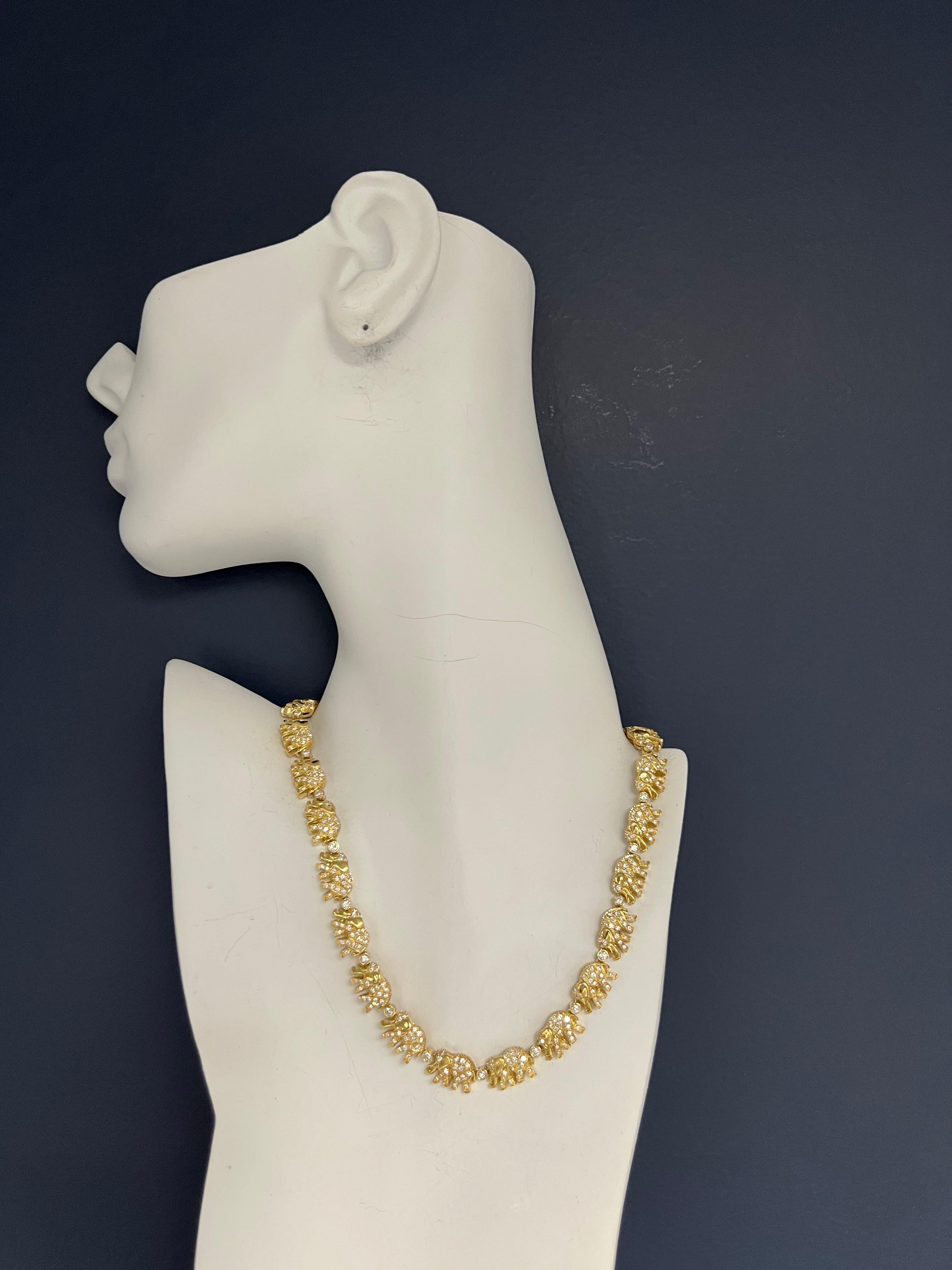 Magnificent 5.50 Carat (appx) Natural Diamond Elephant Necklace set in 18k Yellow Gold. There are 24 elephant links. 

The piece is set with 456 Natural Colorless Round Brilliant Diamonds weighing 5.50 carats, the diamonds are VS-VVS in clarity (all