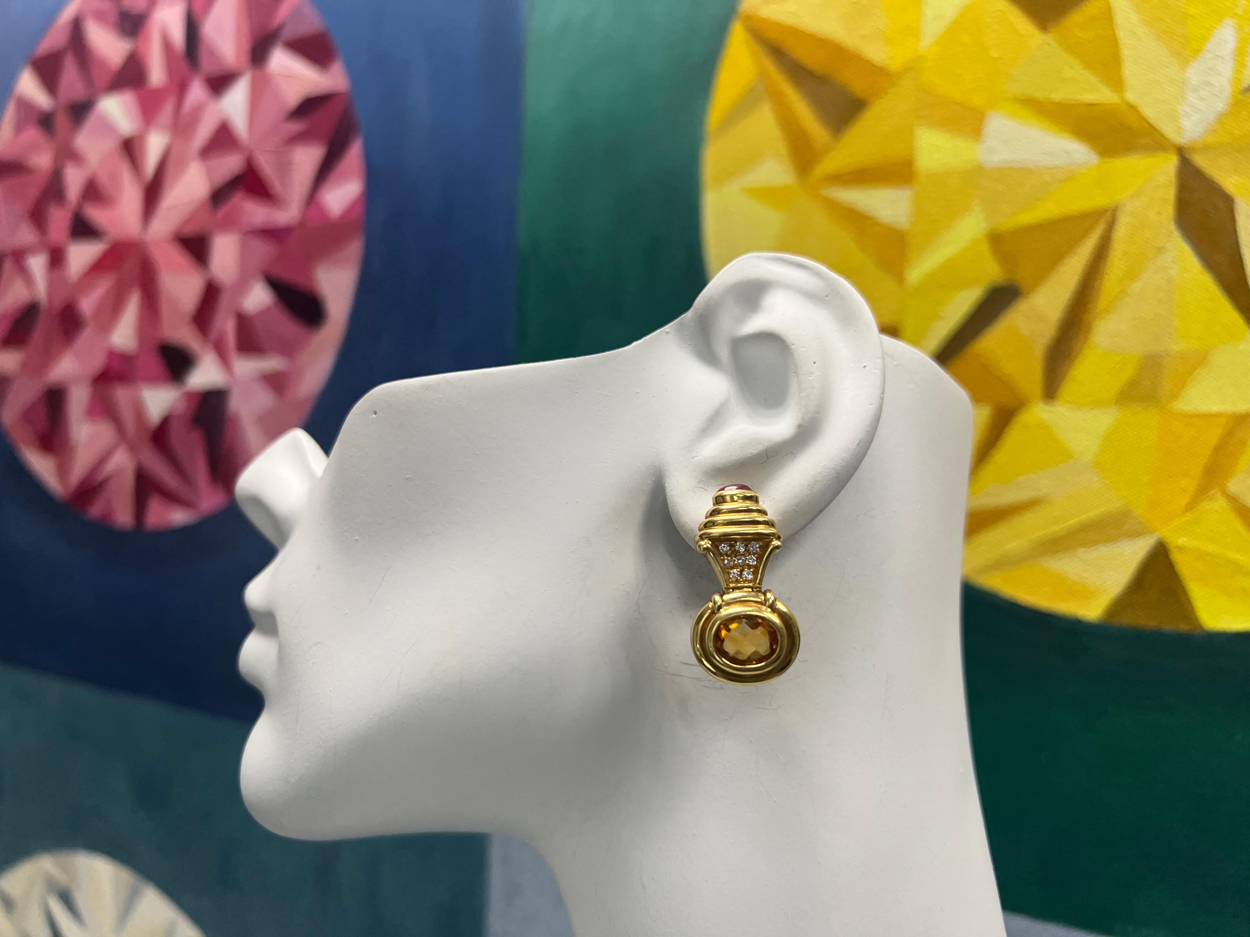 A magnificent 6 carat (appx) 18k yellow gold pair of earrings Set with sixteen natural colorless diamonds weighing approximately 0.35 carats.

The two oval citrines measure approximately 10.5x8.5mmx5.3mm and weigh 5 carats. the cabochons weigh