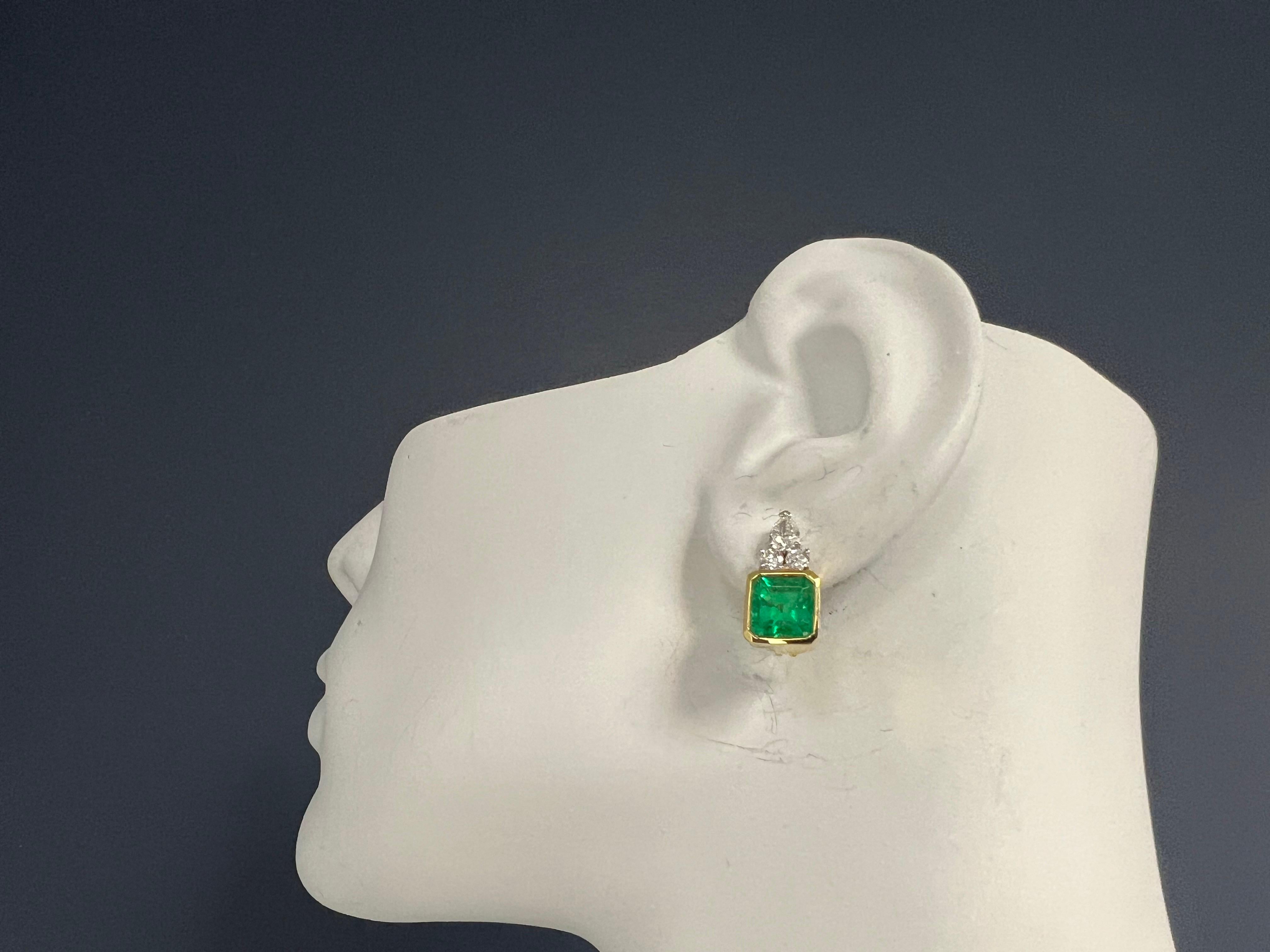 A magnificent pair of GIA certified Natural Green Colombian Emerald earrings, set in 18k yellow and white gold. 

The emeralds are bezel set and weigh approximately 4.75 carats. One is approximately 2.25 carats (7.75x7.7x5.67mm) and the other