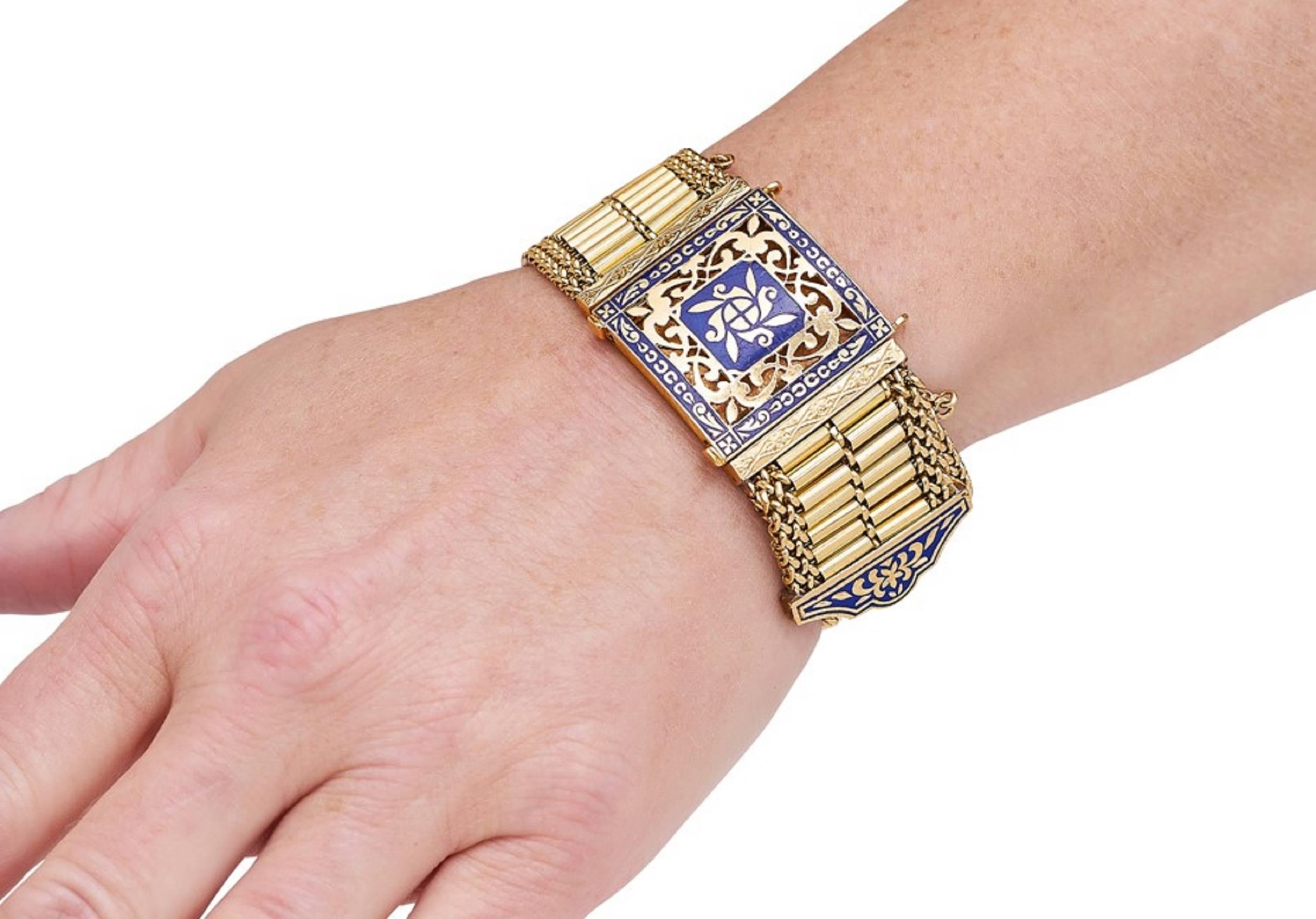 Flexible 14 karat gold, tubular mesh designed buckle bracelet. The center piece is pierced in an intricate design and decorated with inlaid blue enamel  as is the end of the buckle, and completed by a slide closure. 
* Very unique