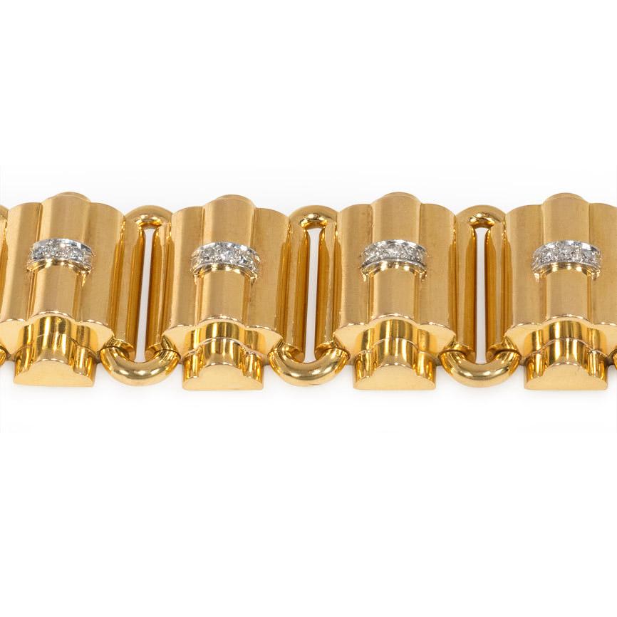 A Retro tank bracelet designed as ribbed, domed links with diamond insets, in 18K gold and platinum. Numbered 9852.