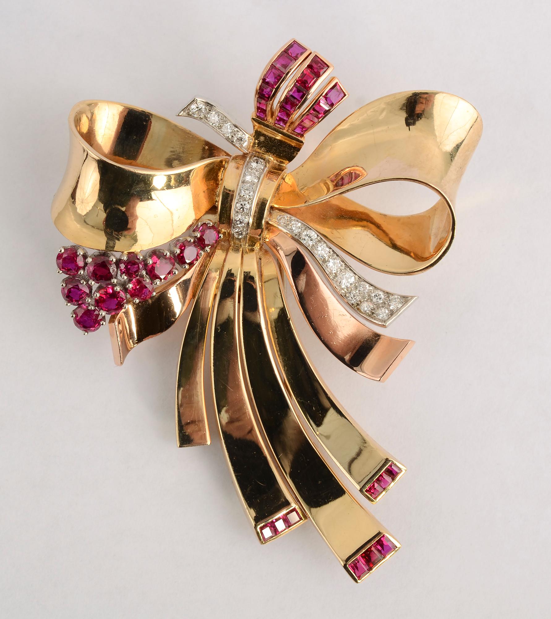 Elegant gold bow brooch with natural rubies and diamonds. The brooch is quintessentially Retro in design. It is finely made with wonderful curvature to the gold effectively giving the look of fabric. Rubies set at the bottom of the brooch are a