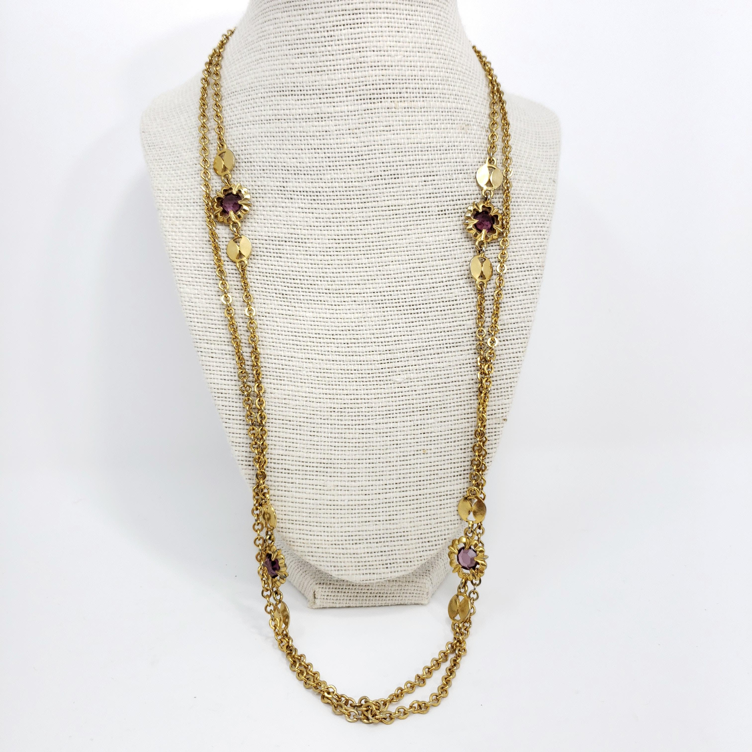 A golden rope-length necklace accented with amethyst crystals, inspired by Victorian style.